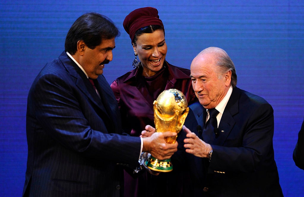 Sepp Blatter hands over the World Cup trophy to the Emir Qatar Sheikh Hamad bin Khalifa Al-Thani in 2010