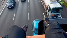 Just Stop Oil protester dangles legs from M25 gantry as group disrupt motorway for second day