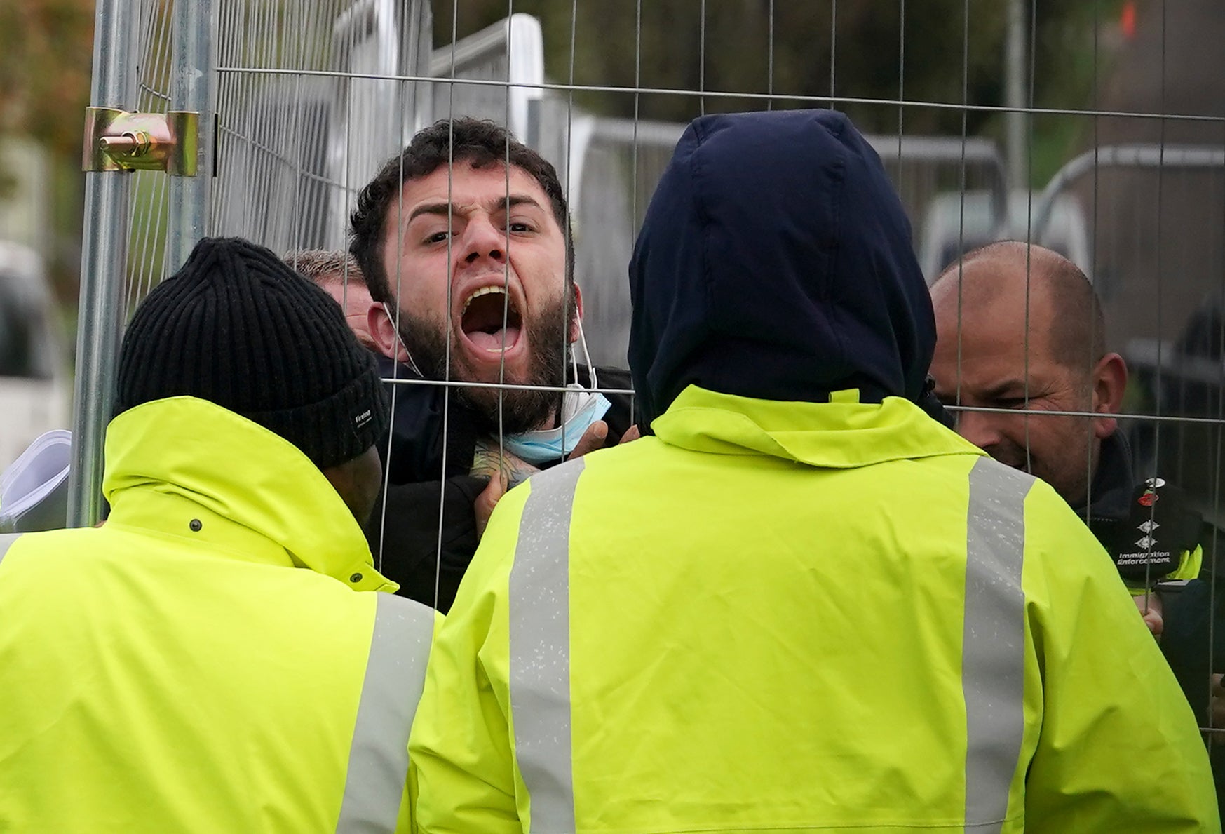 A migrant at Manston attempting to communicate with journalists