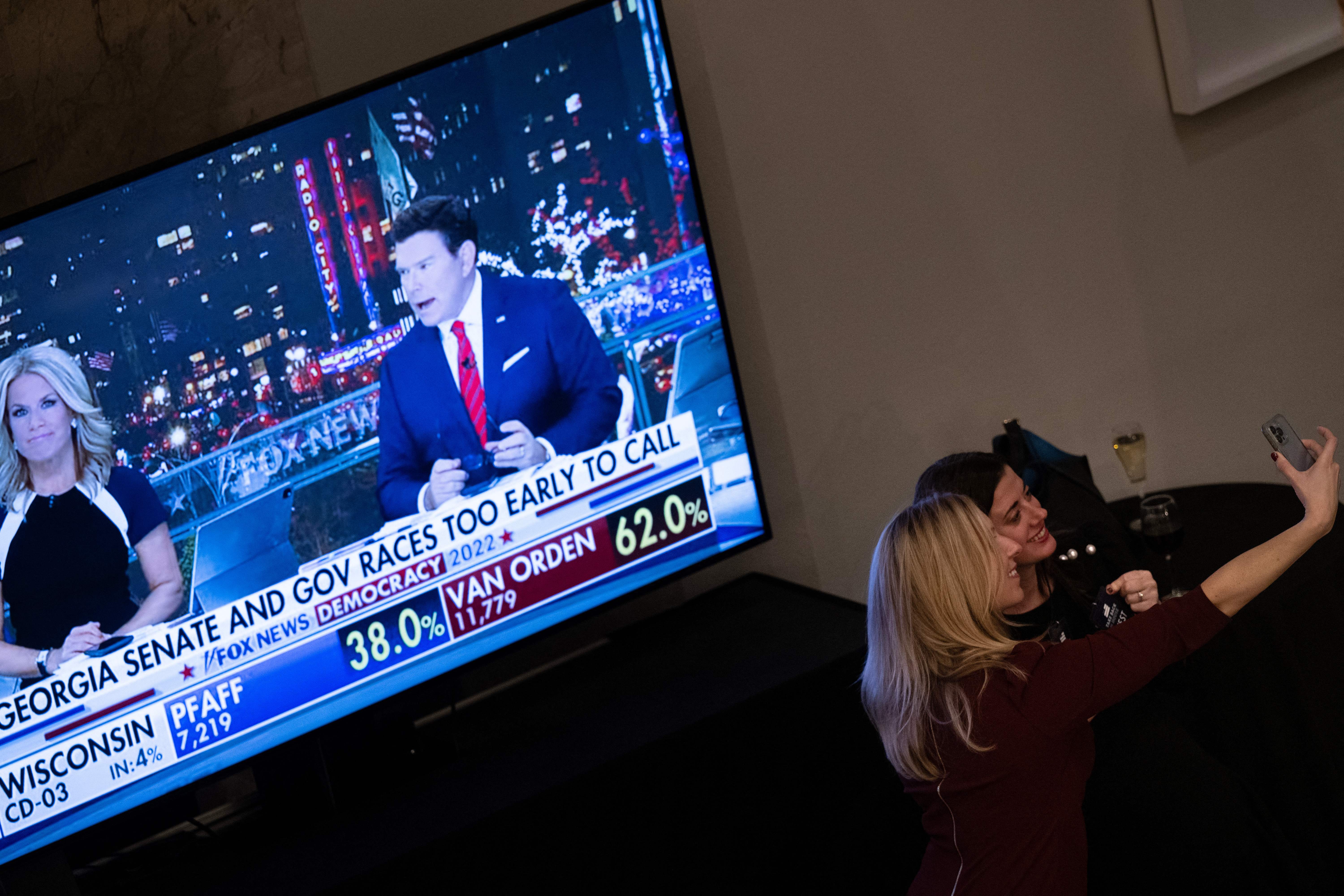 People take a selfie during an election night watch party for the Republican House representative Kevin McCarthy