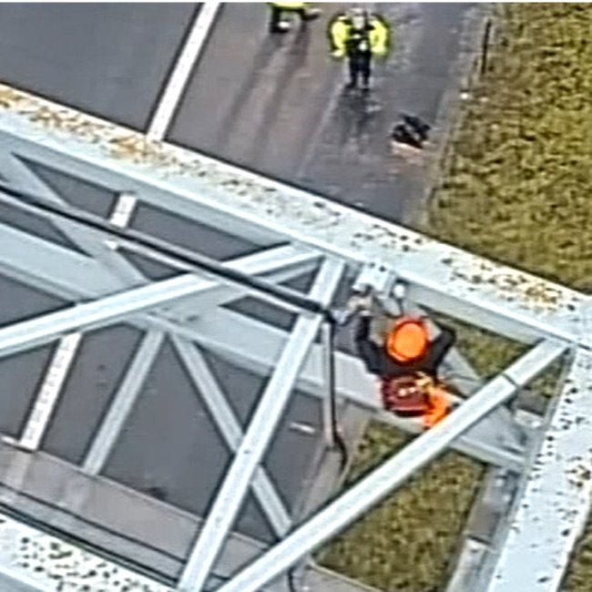 A protester climbs an M25 gantry at Junction 30