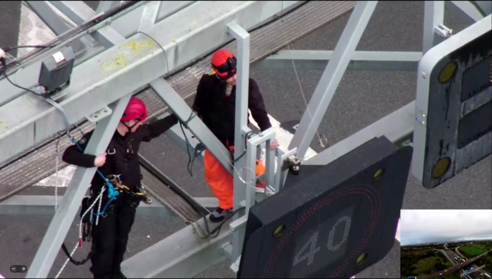 A specialist officer removes a protester from a gantry