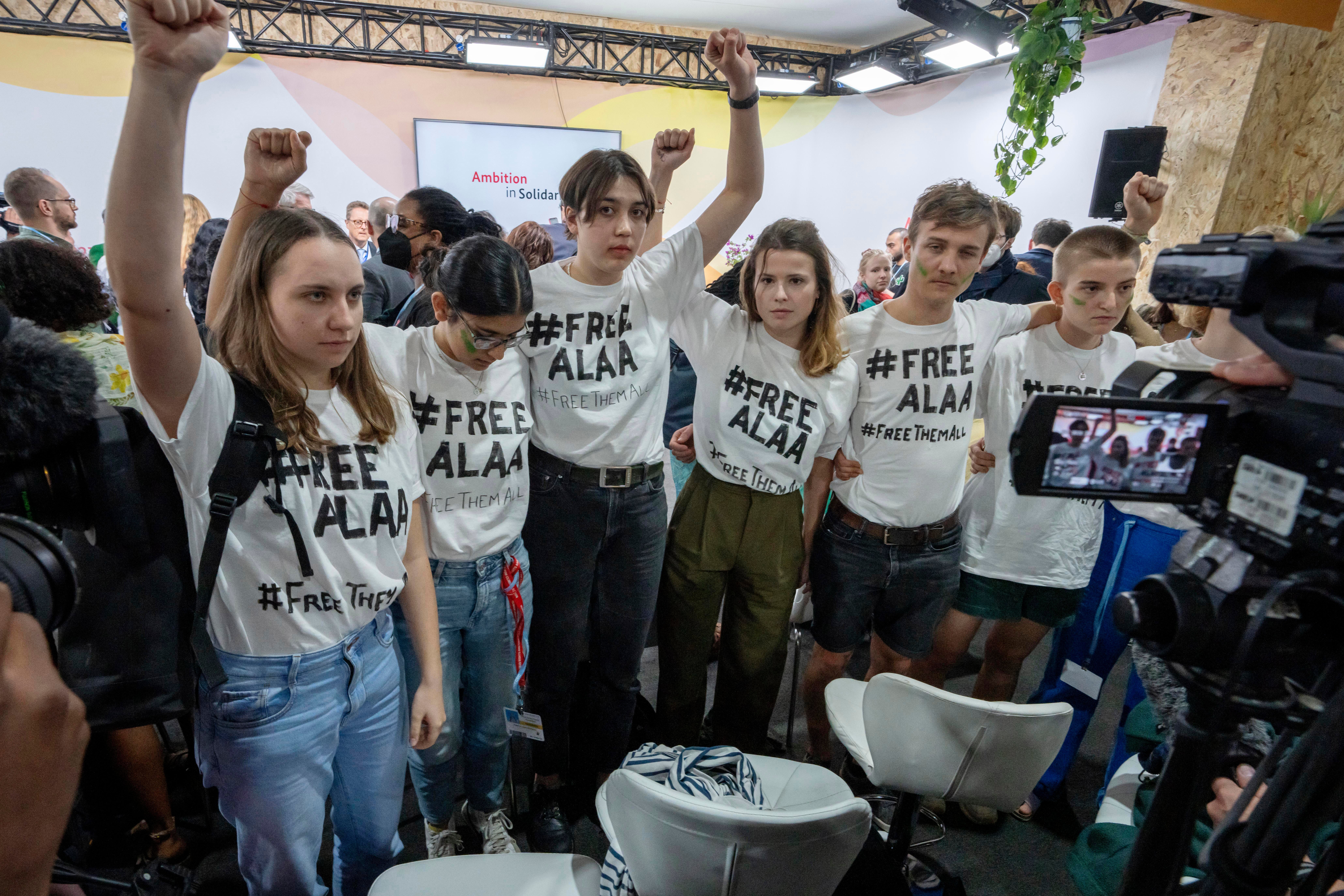 A group of protesters wear T-shirts with #FREEALAA after a panel with Sanaa Seif, sister of Egypt's jailed leading pro-democracy activist Alaa Abdel-Fattah, who is on a hunger and water strike, at COP27