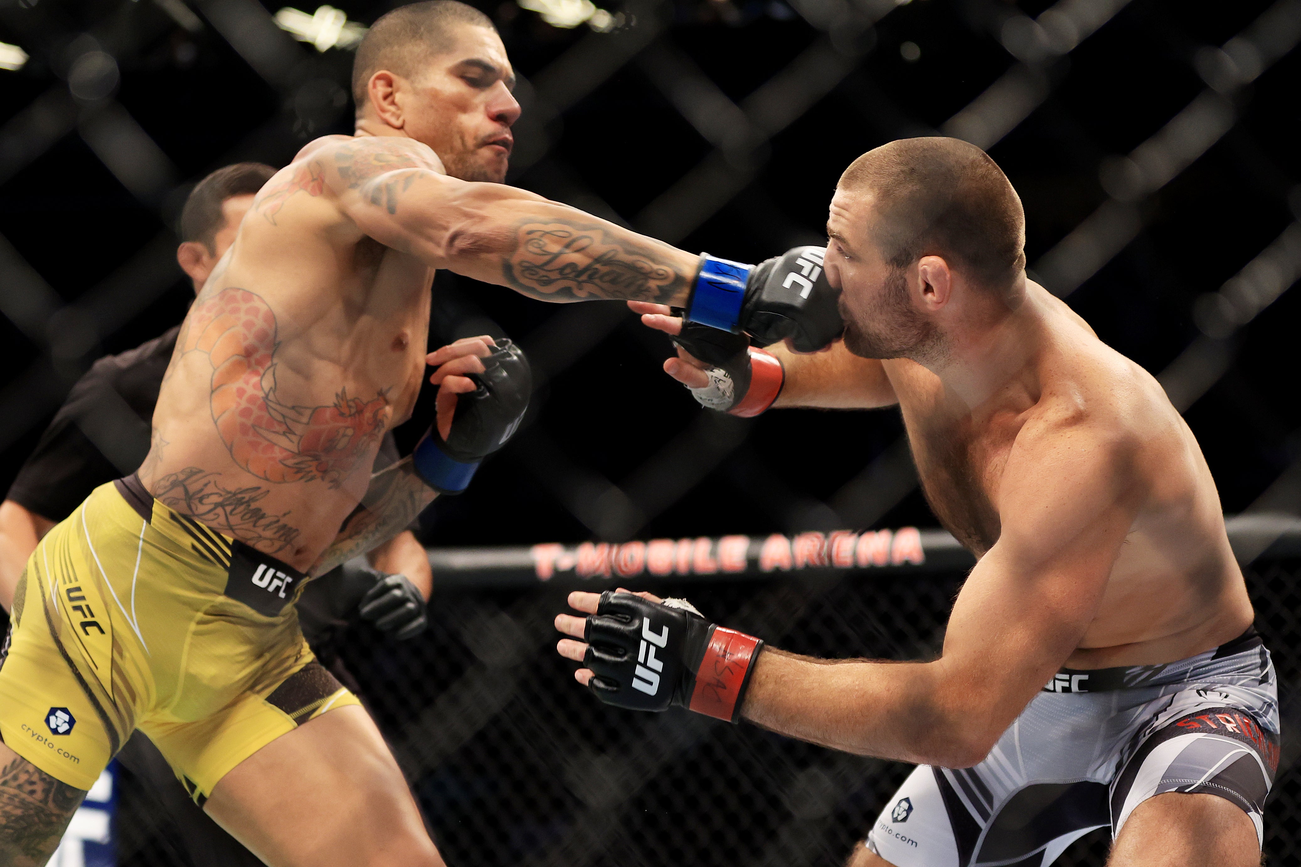 Alex Pereira, left, lands the punch that knocked out Strickland in their fight last year