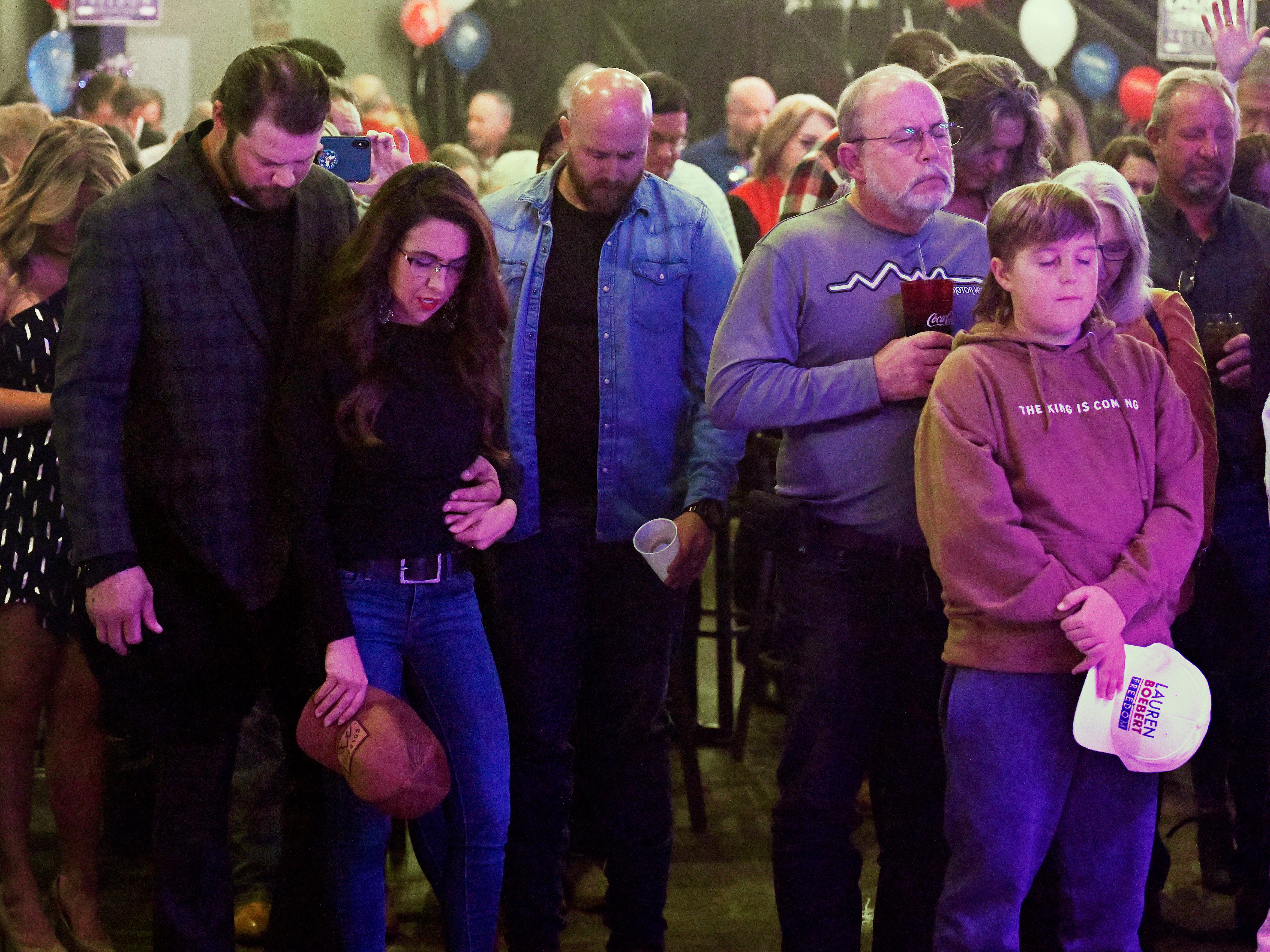 Jayson Boebert puts his arms around his wife, Republican Congresswoman Lauren Boebert, as they pray during an Election night party in Grand Junction, Colo., Tuesday, Nov. 8, 2022