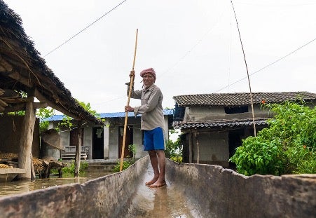 Bhagiram lost his home in Bardiya district, western Nepal, but rescued his family with his rickety wooden boat. He received anticipatory action cash support from WFP