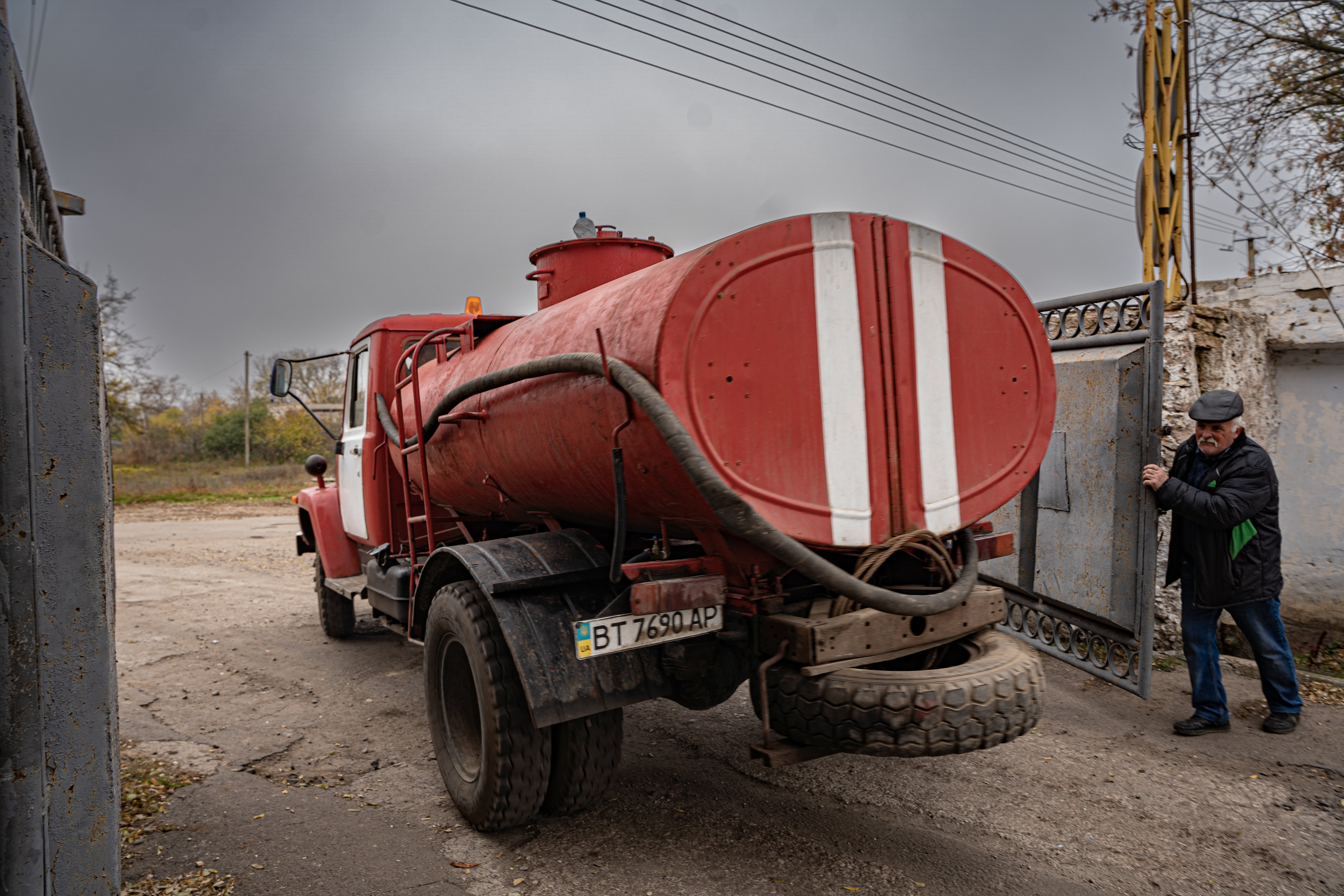 Oleksandr helps a fire truck carrying water