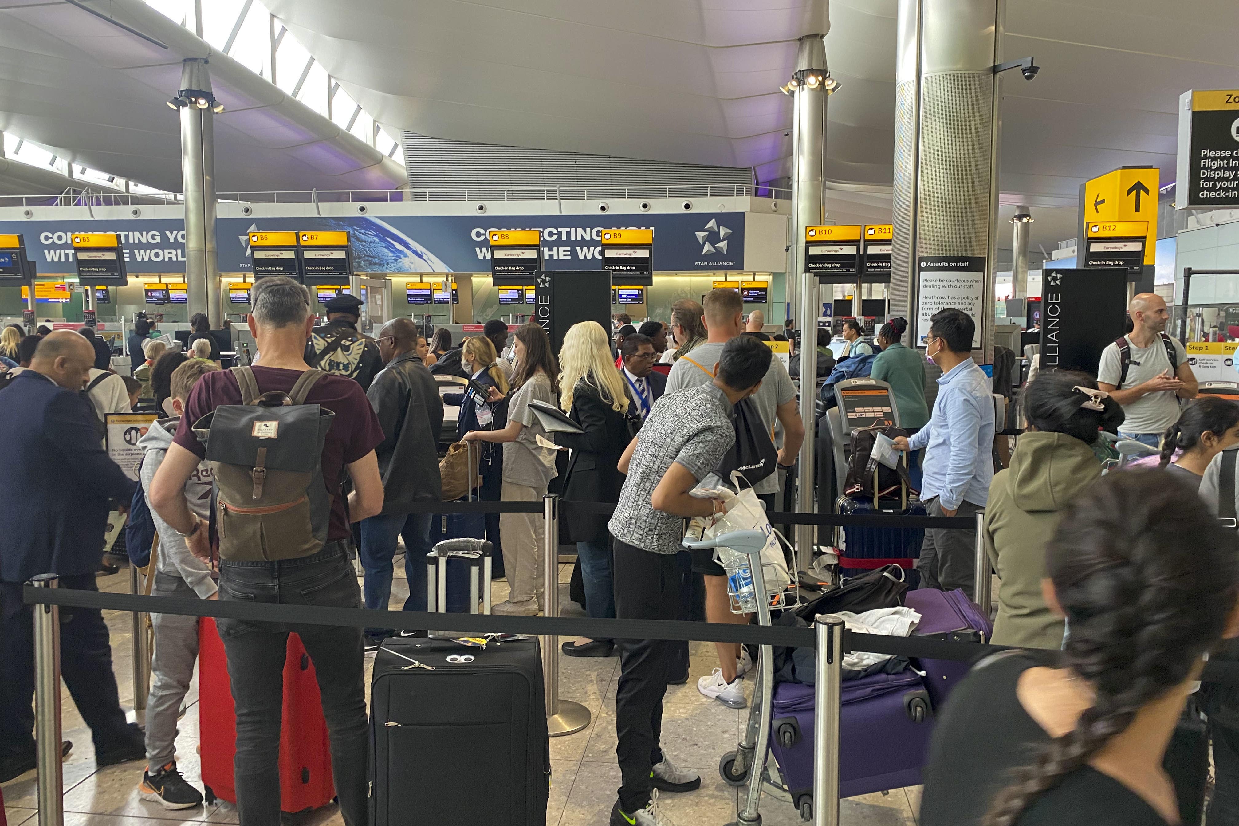 Passengers queue to check-in at terminal 2 at Heathrow Airport, London (Steve Parsons/PA)