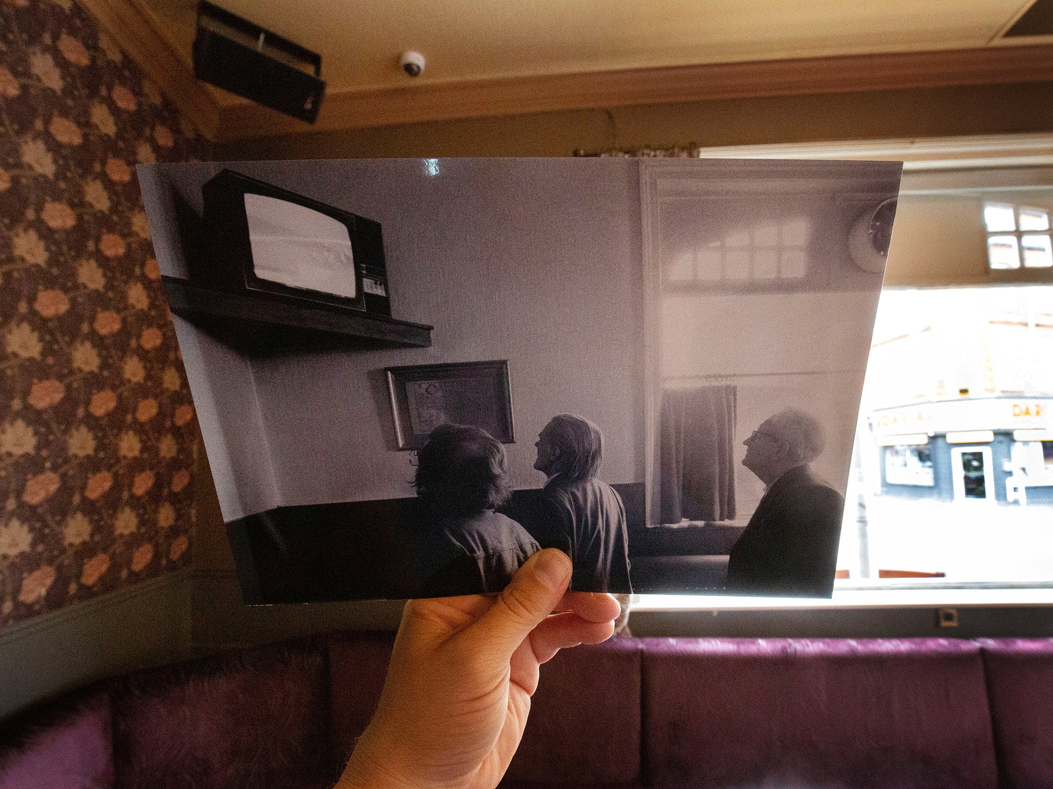 Three men watch the racing in 1983