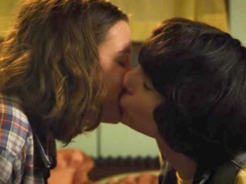 Eleven (Millie Bobby Brown) and Mike (Finn Wolfhard) kiss in ‘Stranger Things’