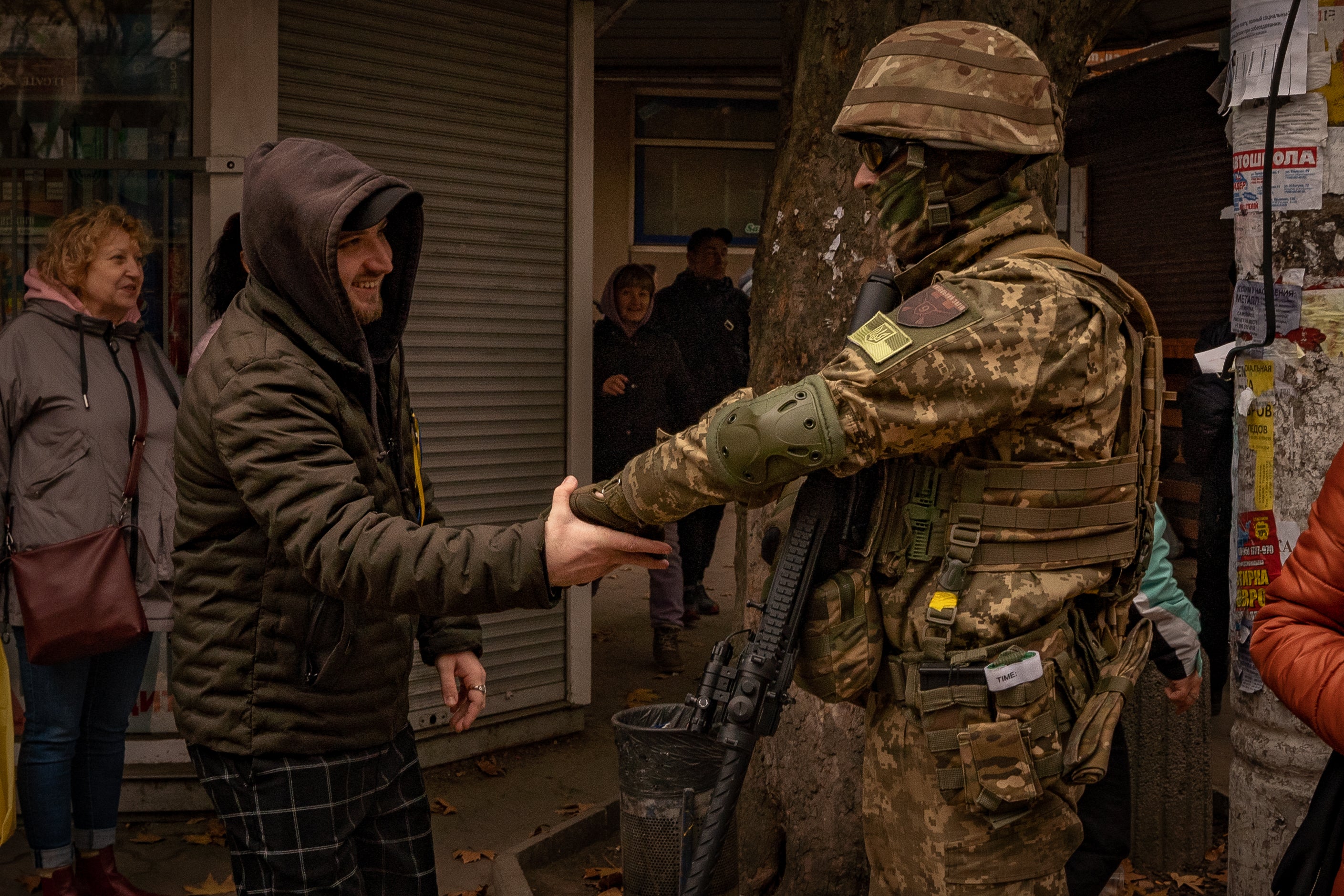 Residents of Kherson embrace a Ukrainian soldier