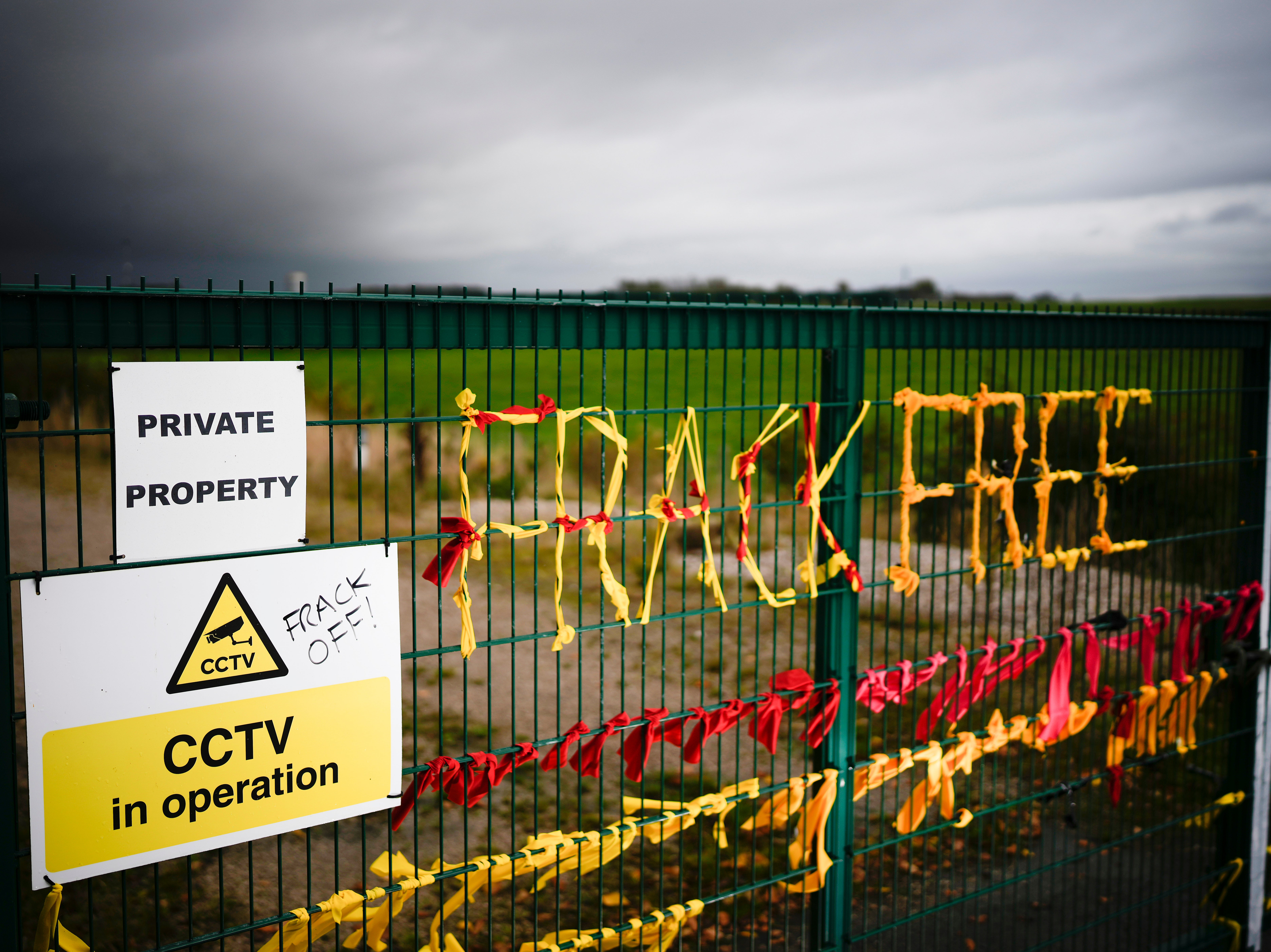 Ribbons threaded through a gate read ‘Frack Free’, at shale gas firm Cuadrilla’s Preston New Road site, Lancashire, in October 2022