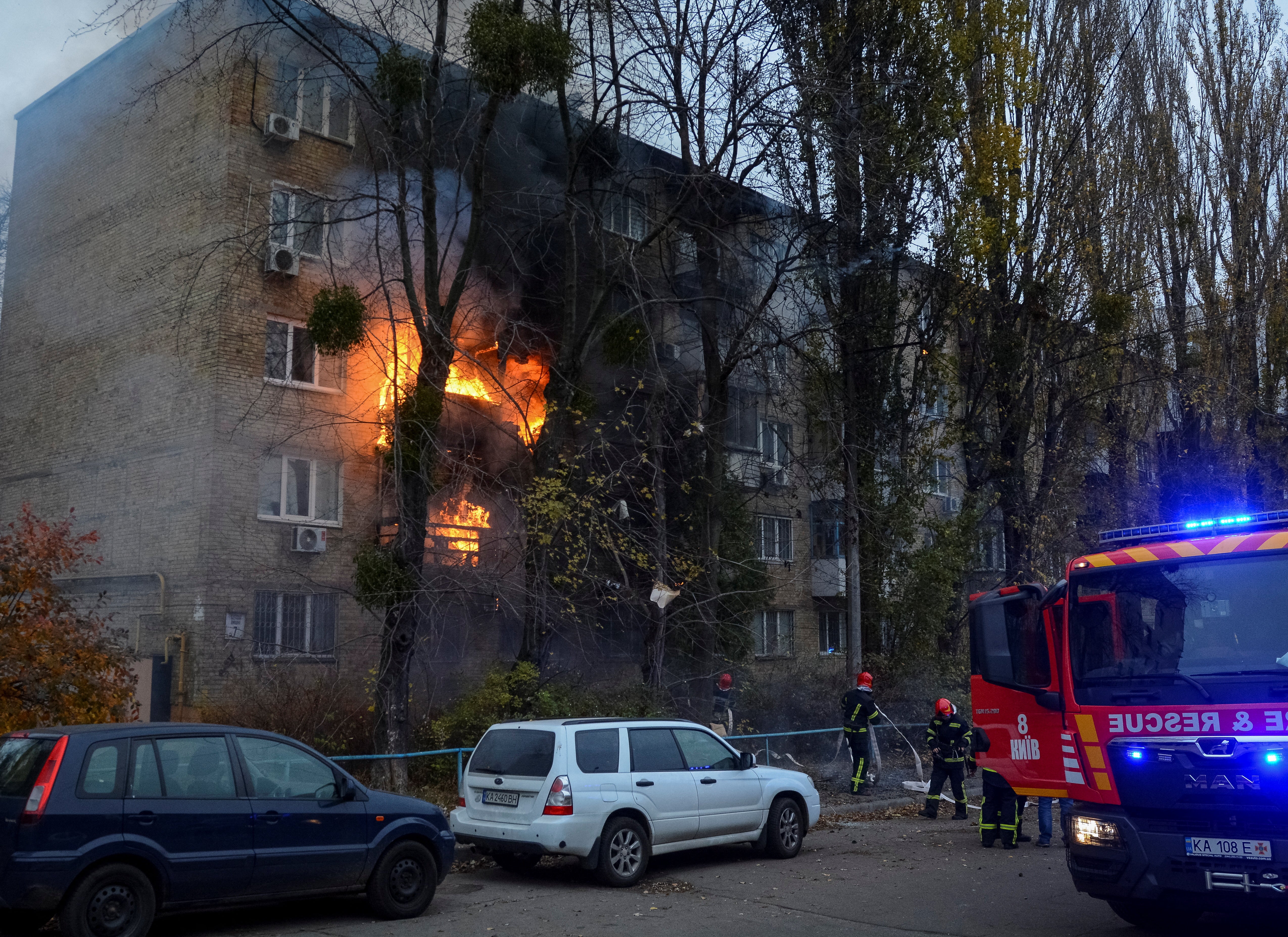 Firefighters work to put out a fire in a residential building