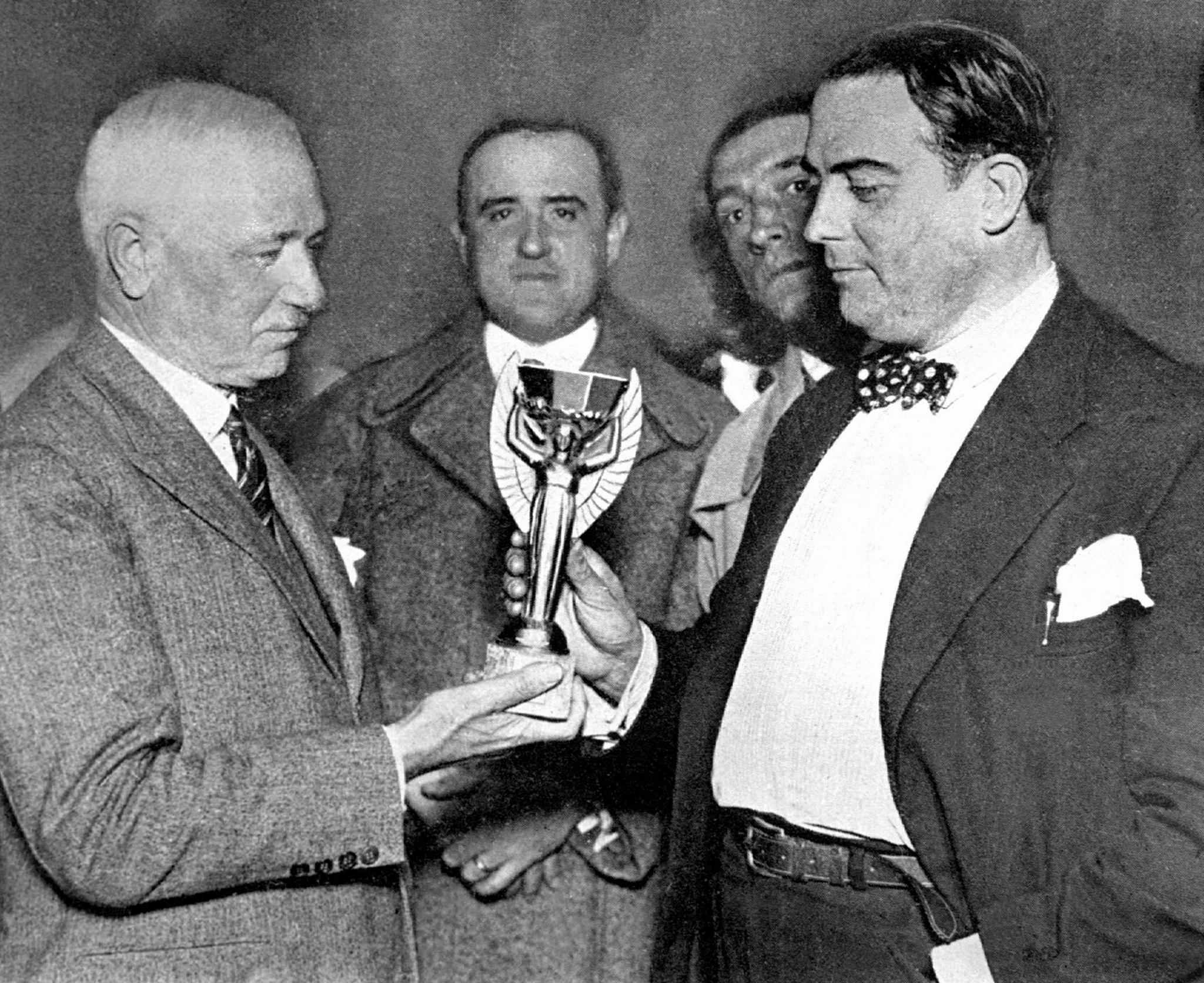 Fifa president Jules Rimet presents the first World Cup to Uruguay