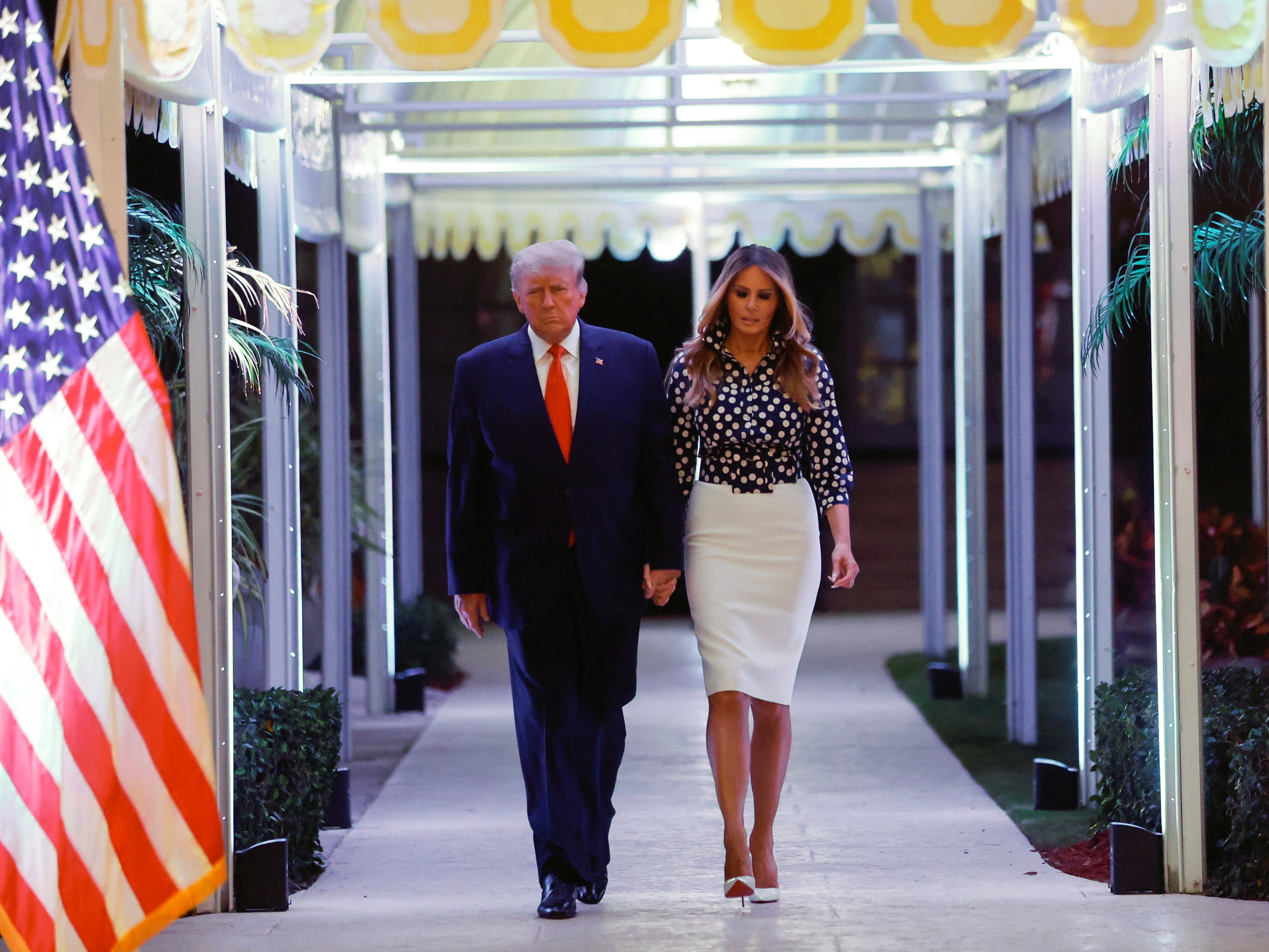 Donald and Melania Trump enter the venue at their Mar-a-Lago estate in Palm Beach, Florida, on 15 November