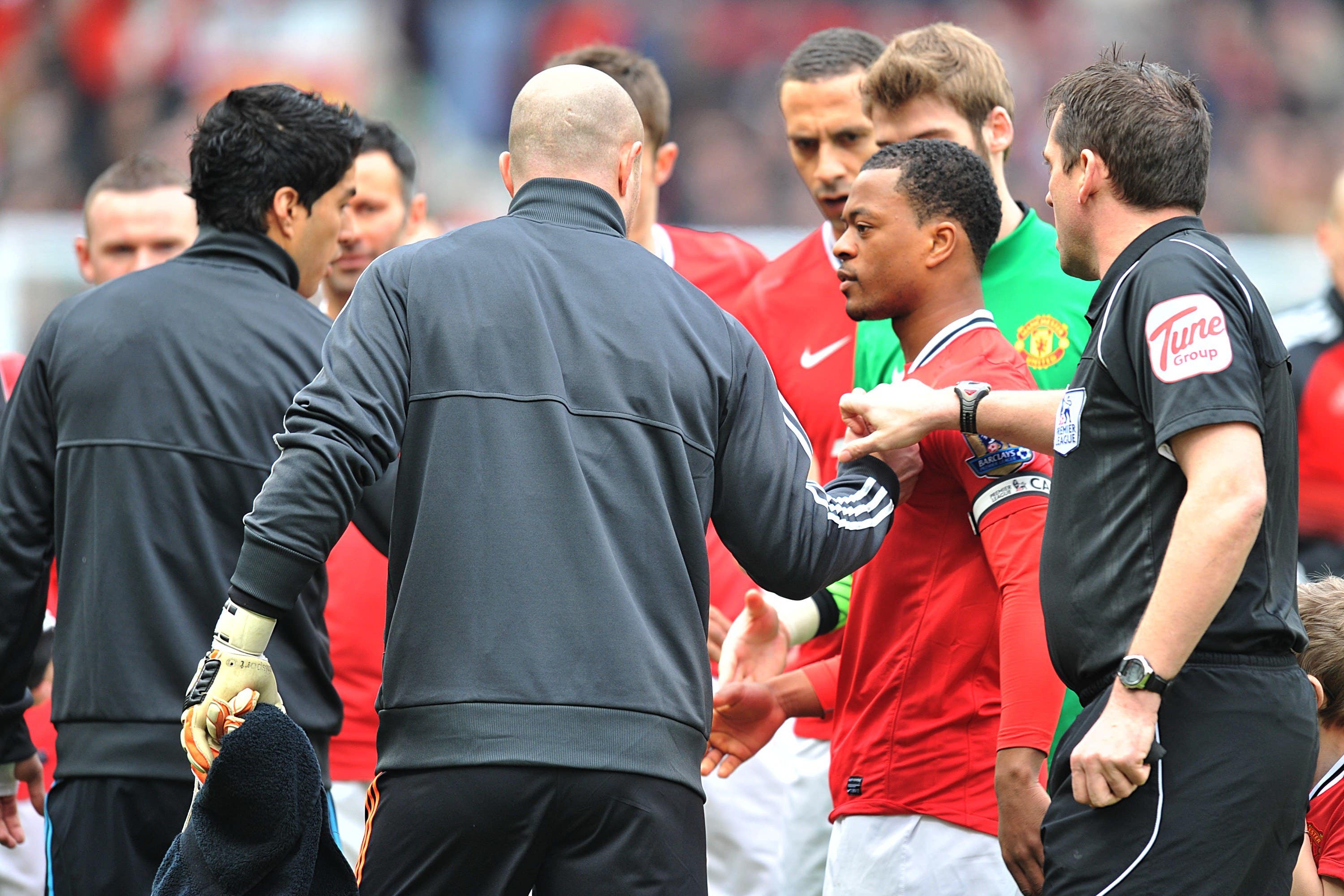 Liverpool’s Luis Suarez (left) refuses to shake the hand of Manchester United’s Patrice Evra (Martin Rickett/PA)