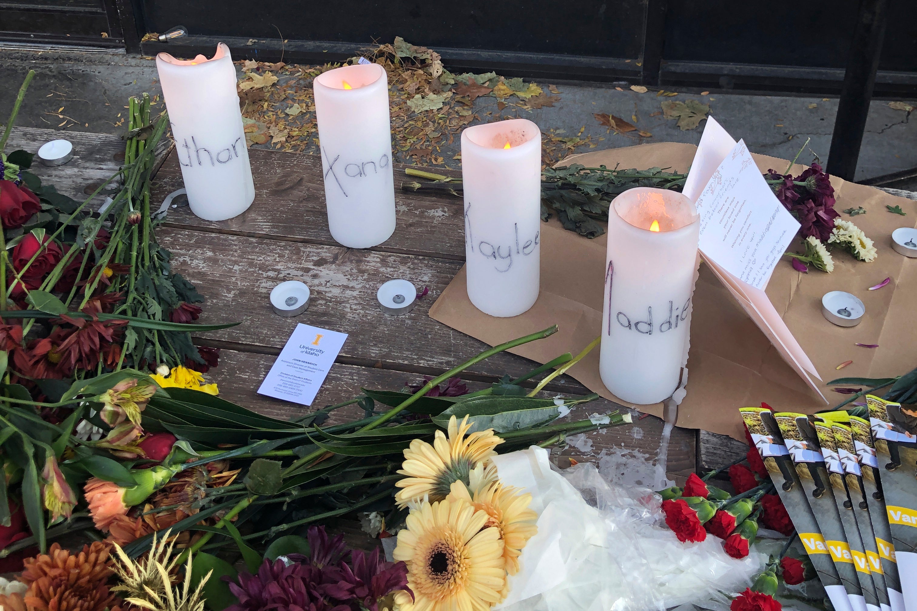 Candles and flowers are left at a make-shift memorial honoring four slain University of Idaho students