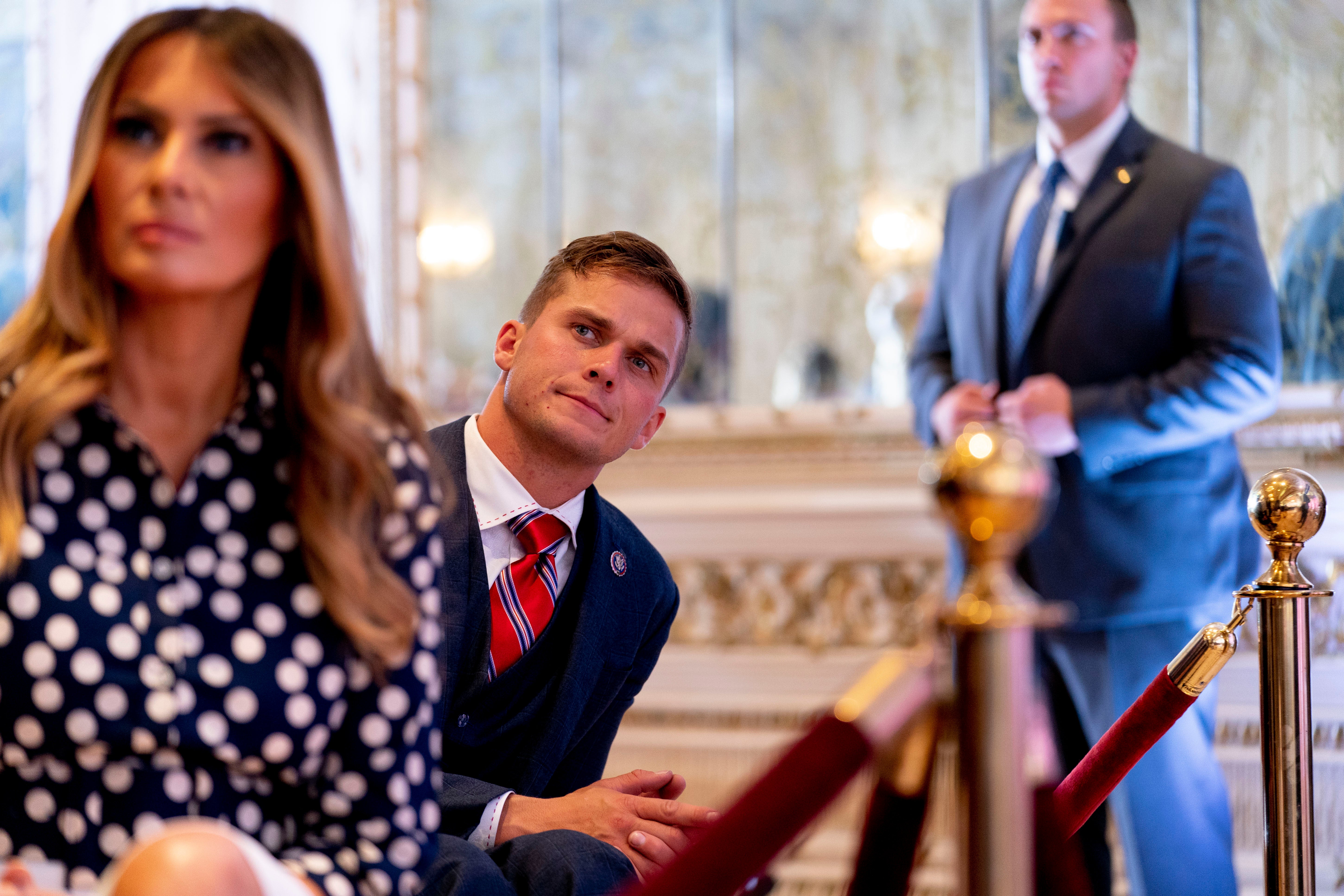 Former first lady Melania Trump, left, and Rep Madison Cawthorn, centre, at Mar-a-Lago