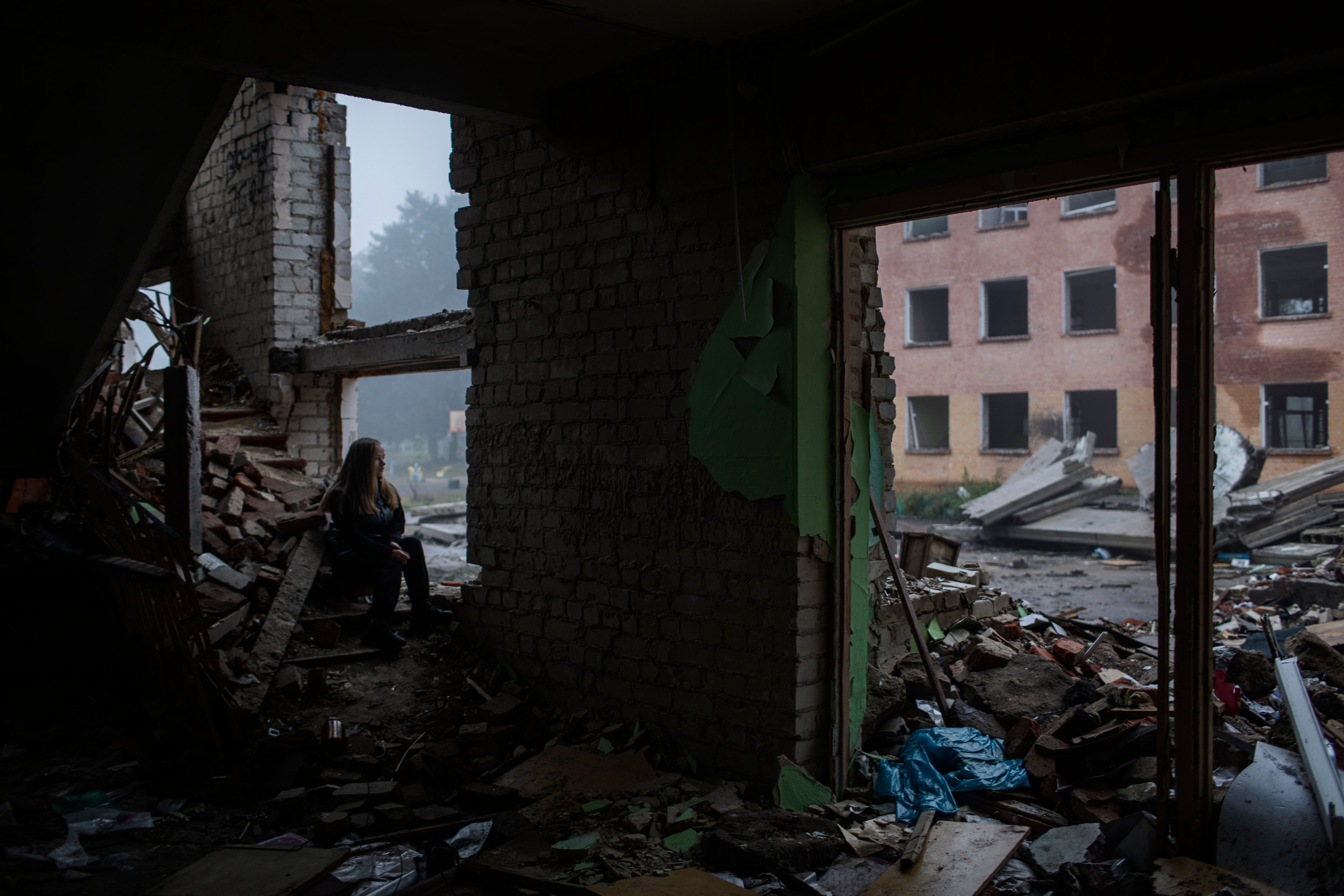 Viktoria Rudenko 14, sits inside her destroyed school