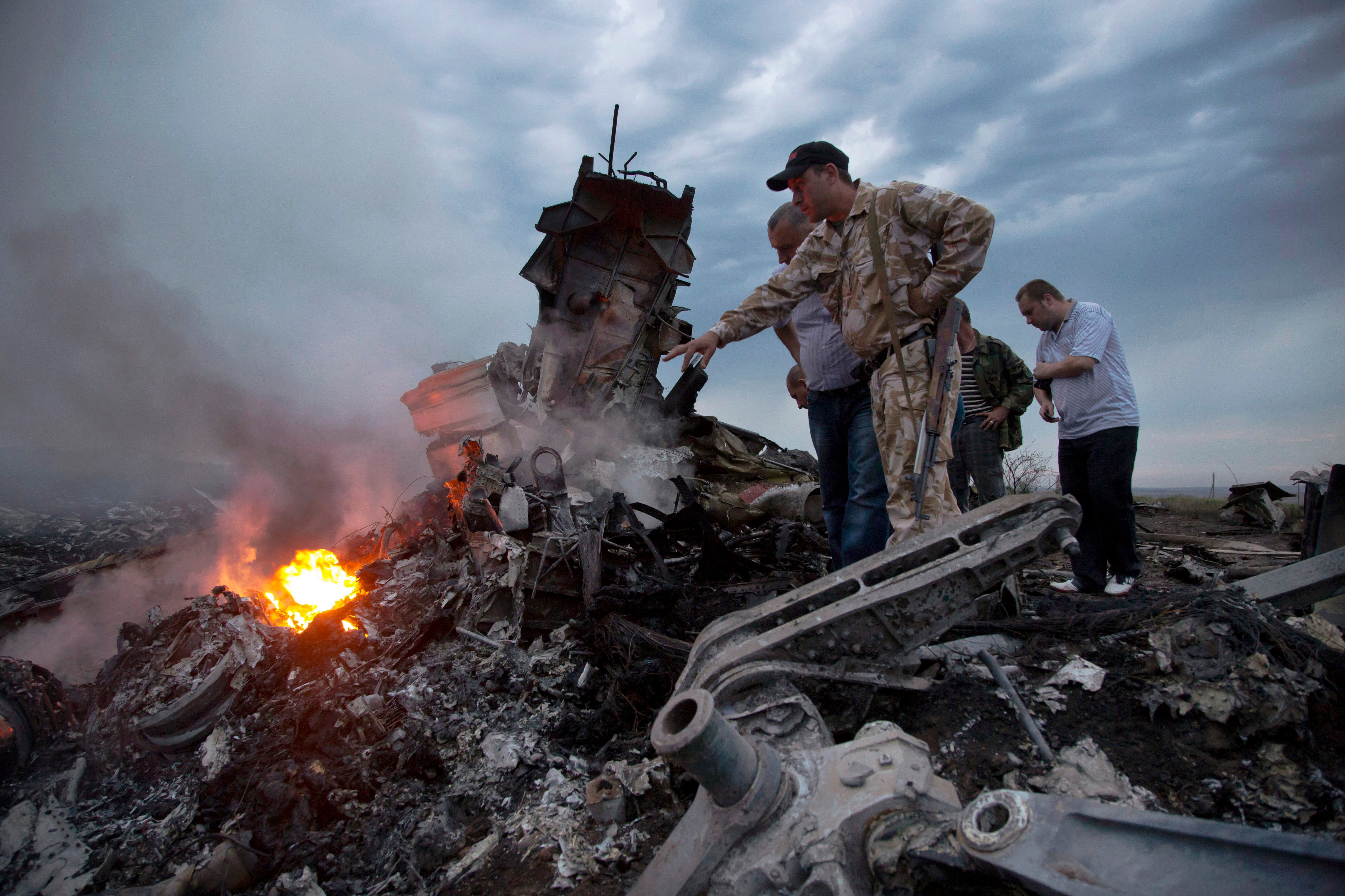 People look through plane ruins