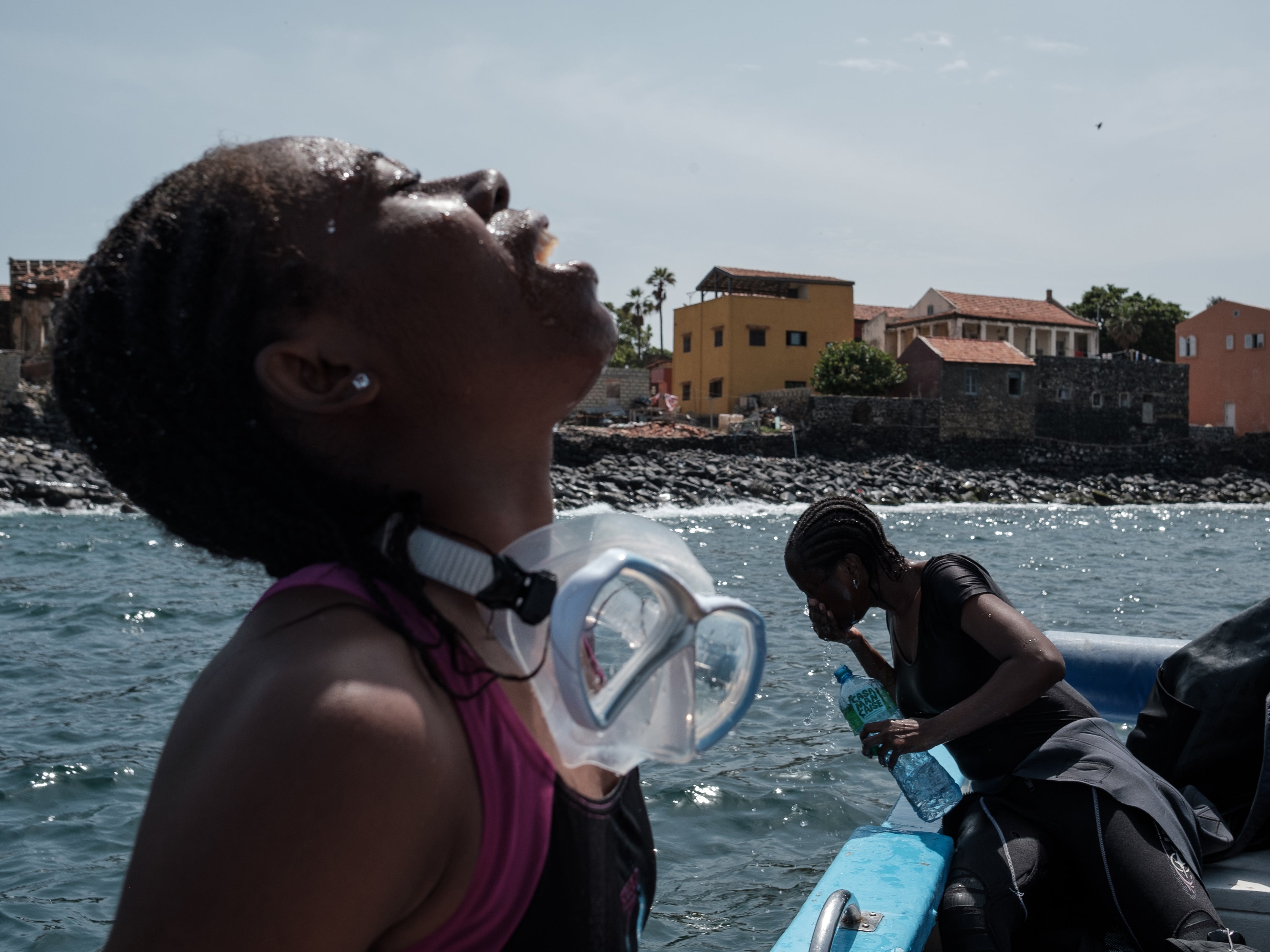 Grace Grodje, a doctoral student in maritime archaeology, gargles to clear her mouth after a morning dive