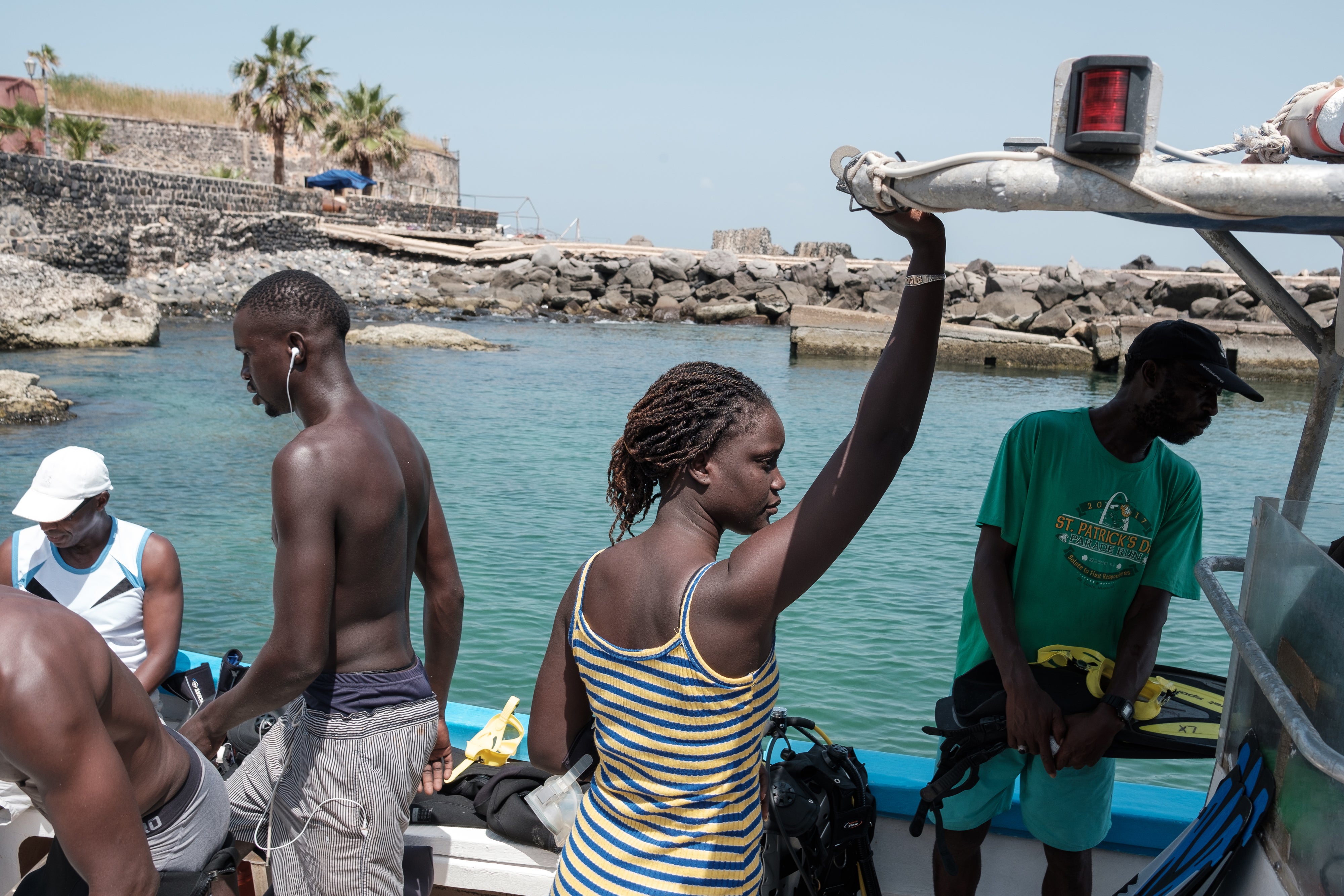 Aminata Mbaye stands on the dive boat as the group prepares for the final descent of the October programme