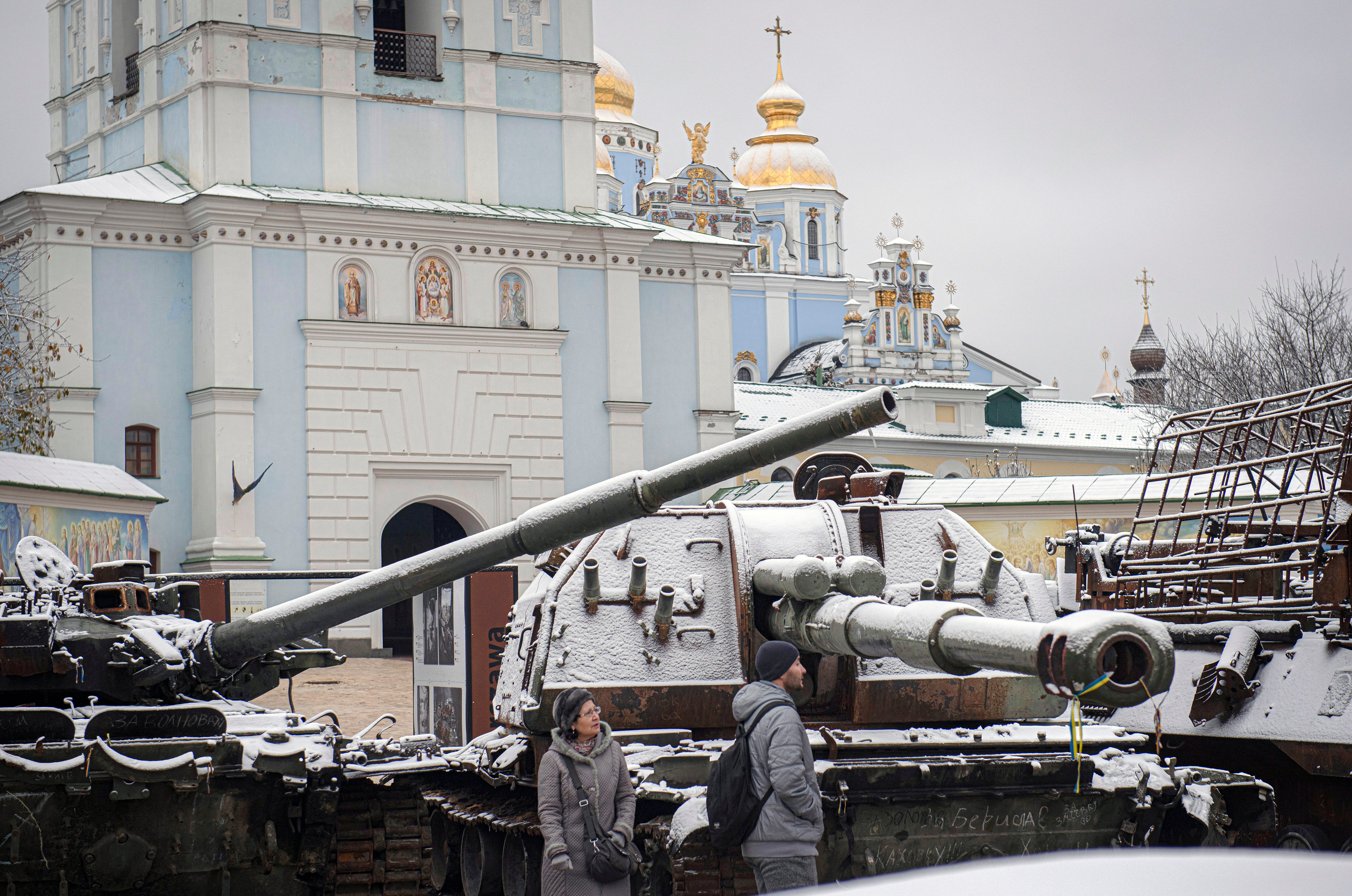 Residents walk between captured Russian tanks and armoured vehicles in Kyiv on Thursday