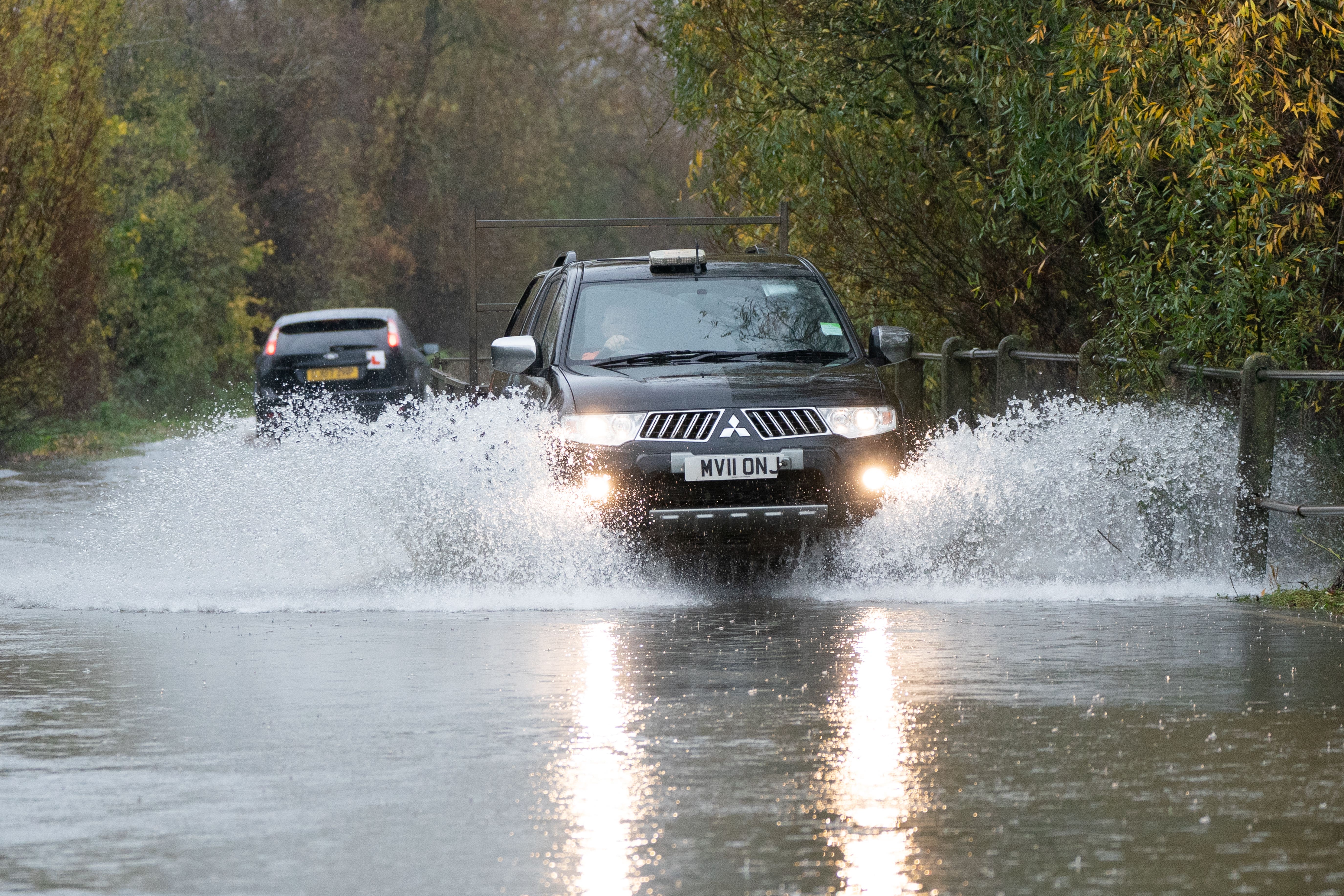 A motorist drives along a flooded road in Mountsorrel, Leicestershire