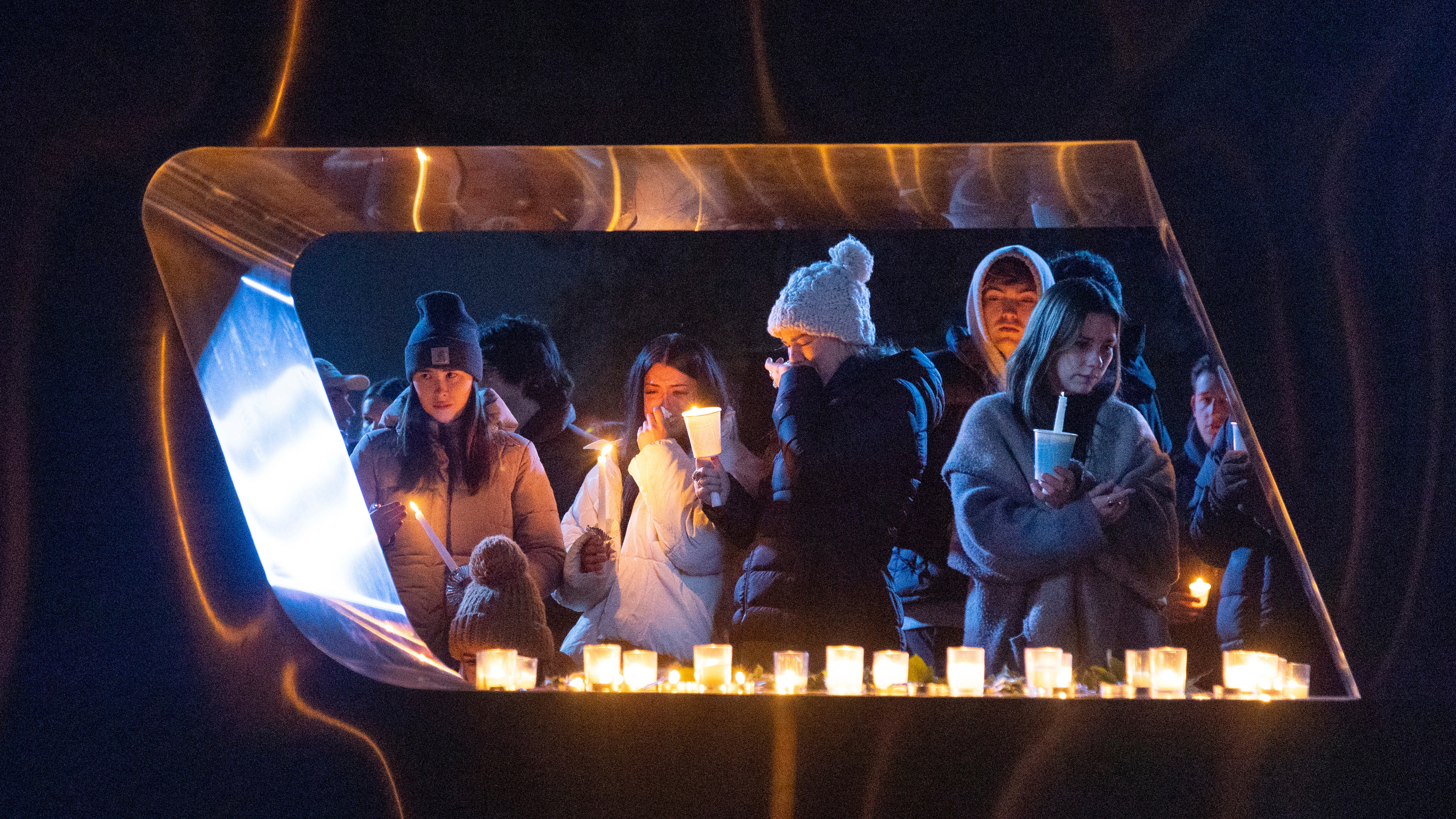 Students pay tribute to the four murdered students at a vigil on the weekend