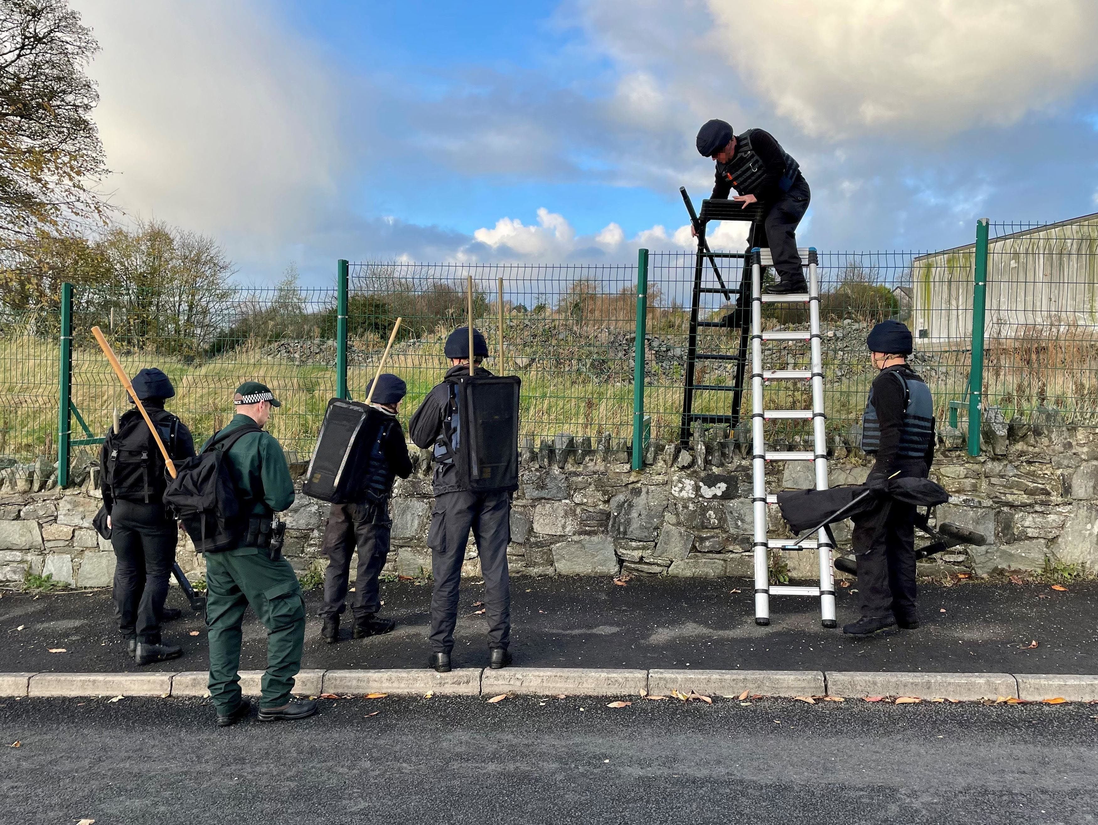 Army search teams assisted by the PSNI at the scene, following the attempted murder of two officers in Strabane