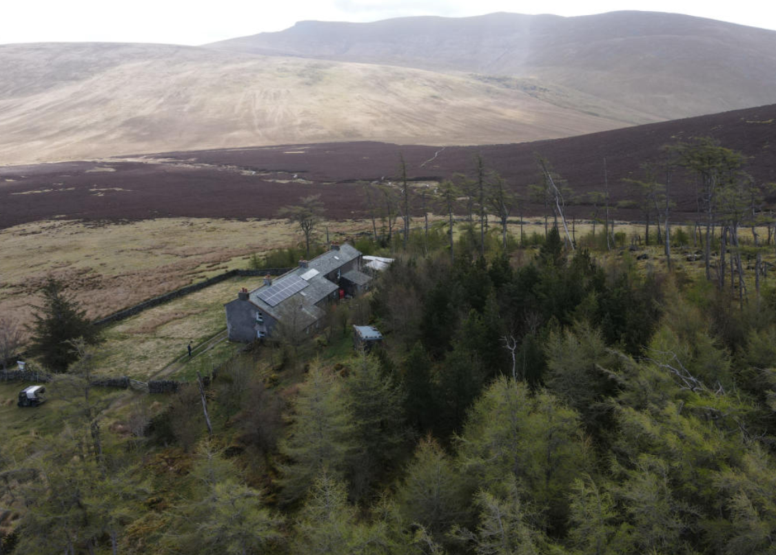 A view of the rear of Skiddaw House and surrounding moorland