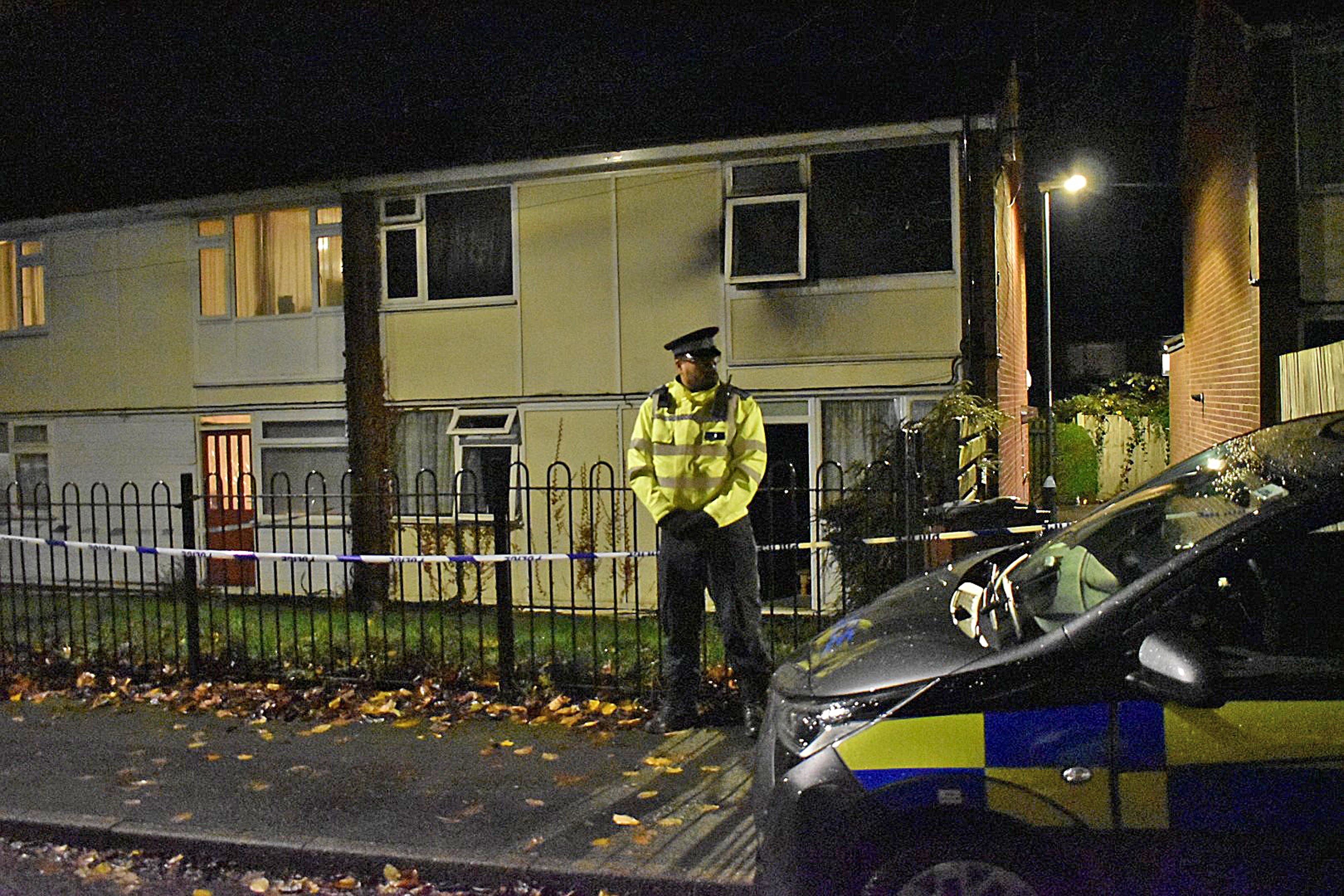 Police at the scene in Nottingham after two children died and a woman was left critically injured in a fire at a flat