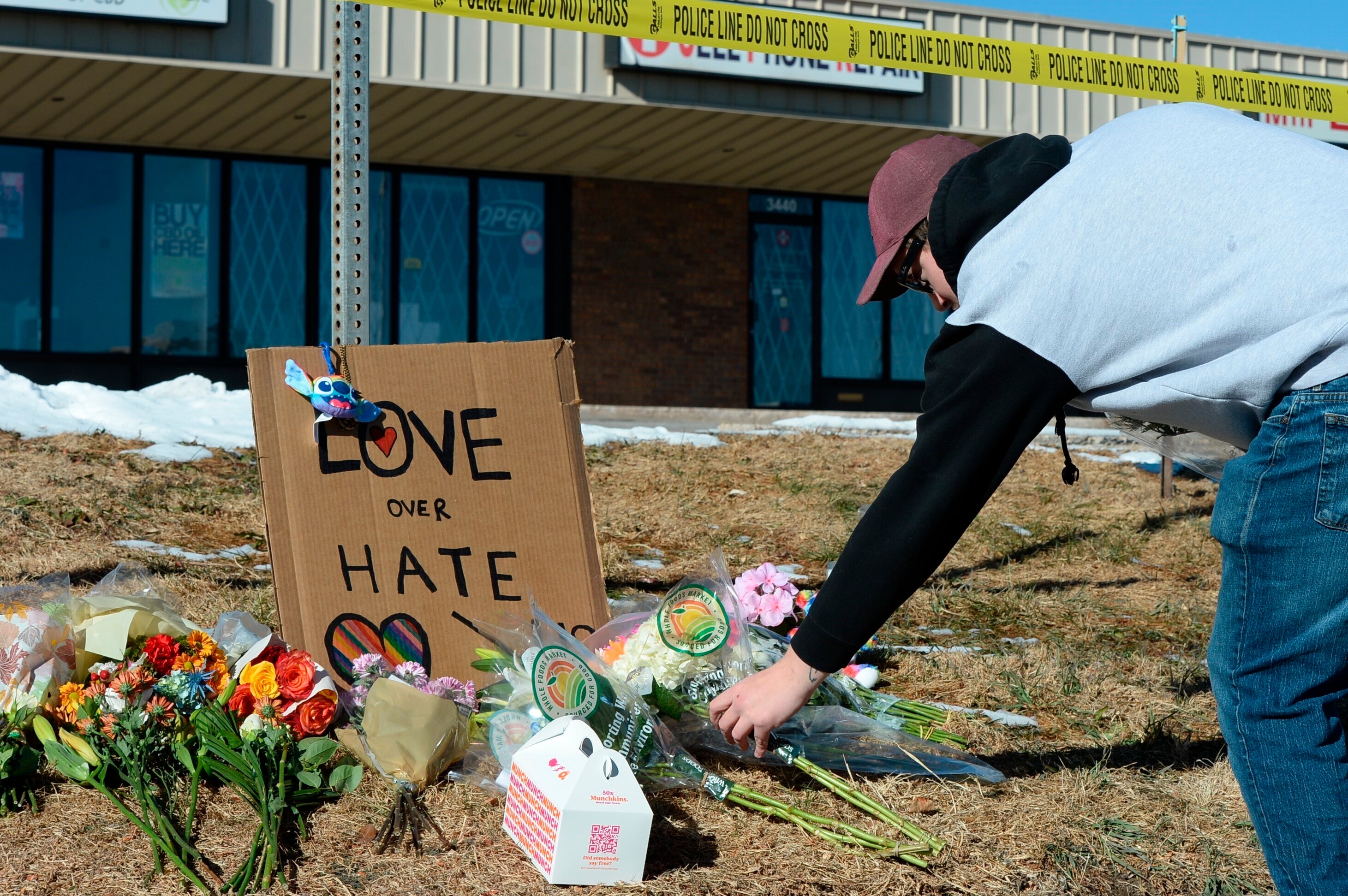 Mourners leave flowers outside Club Q in Colorado Springs after Saturday’s mass shooting