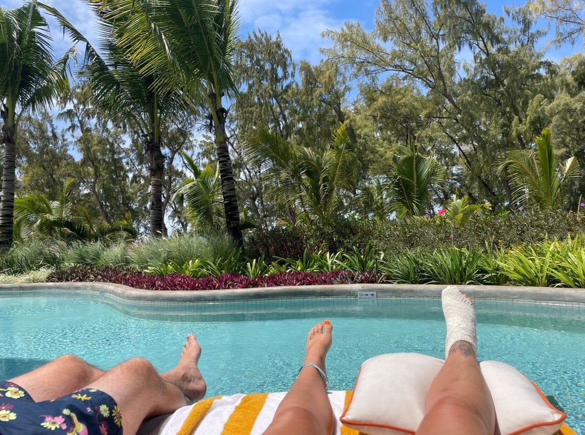 Amy with her bandaged foot by the pool in Mauritius