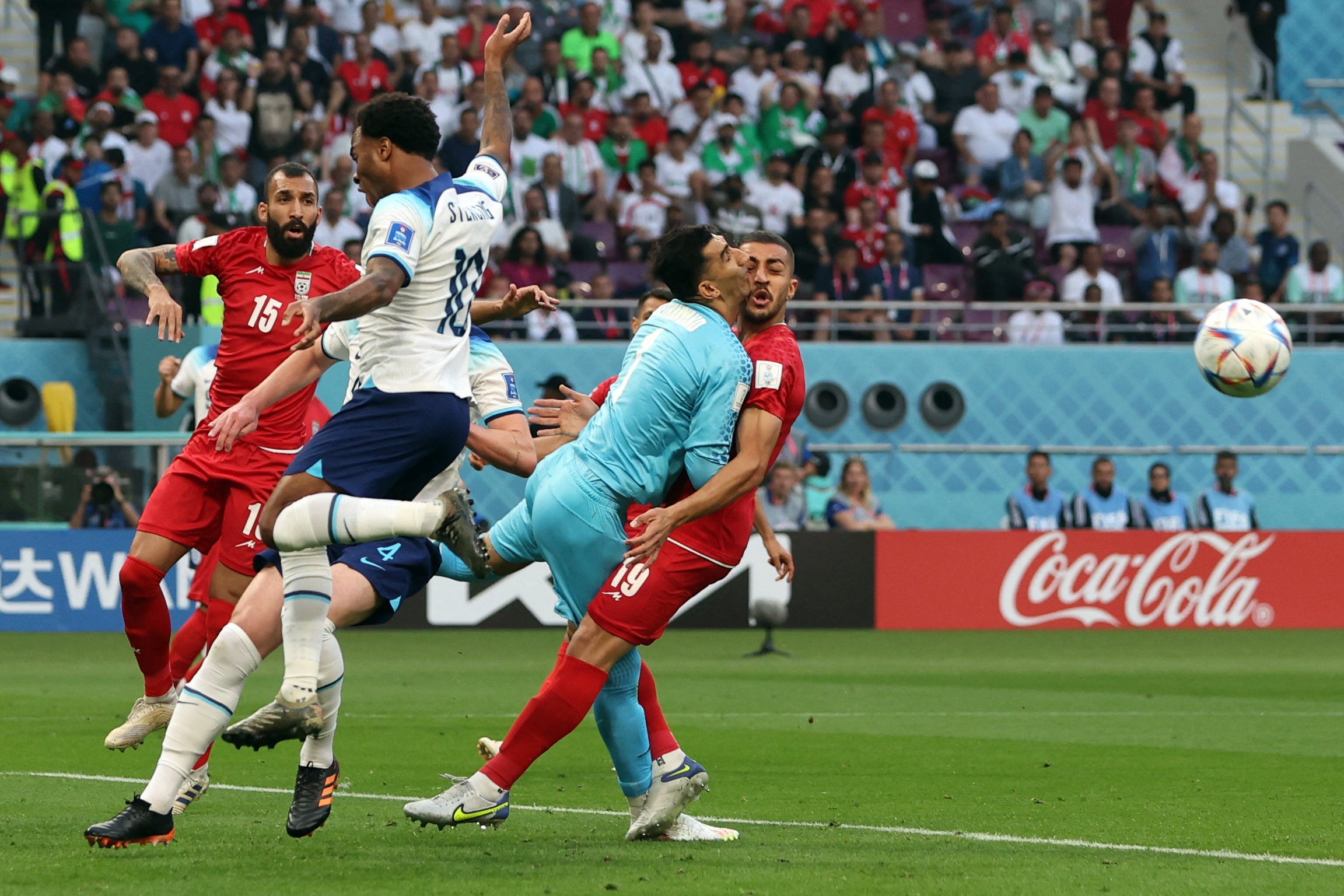 Iran's Alireza Beiranvand collides into Majid Hosseini resulting in being substituted off with a concussion injury