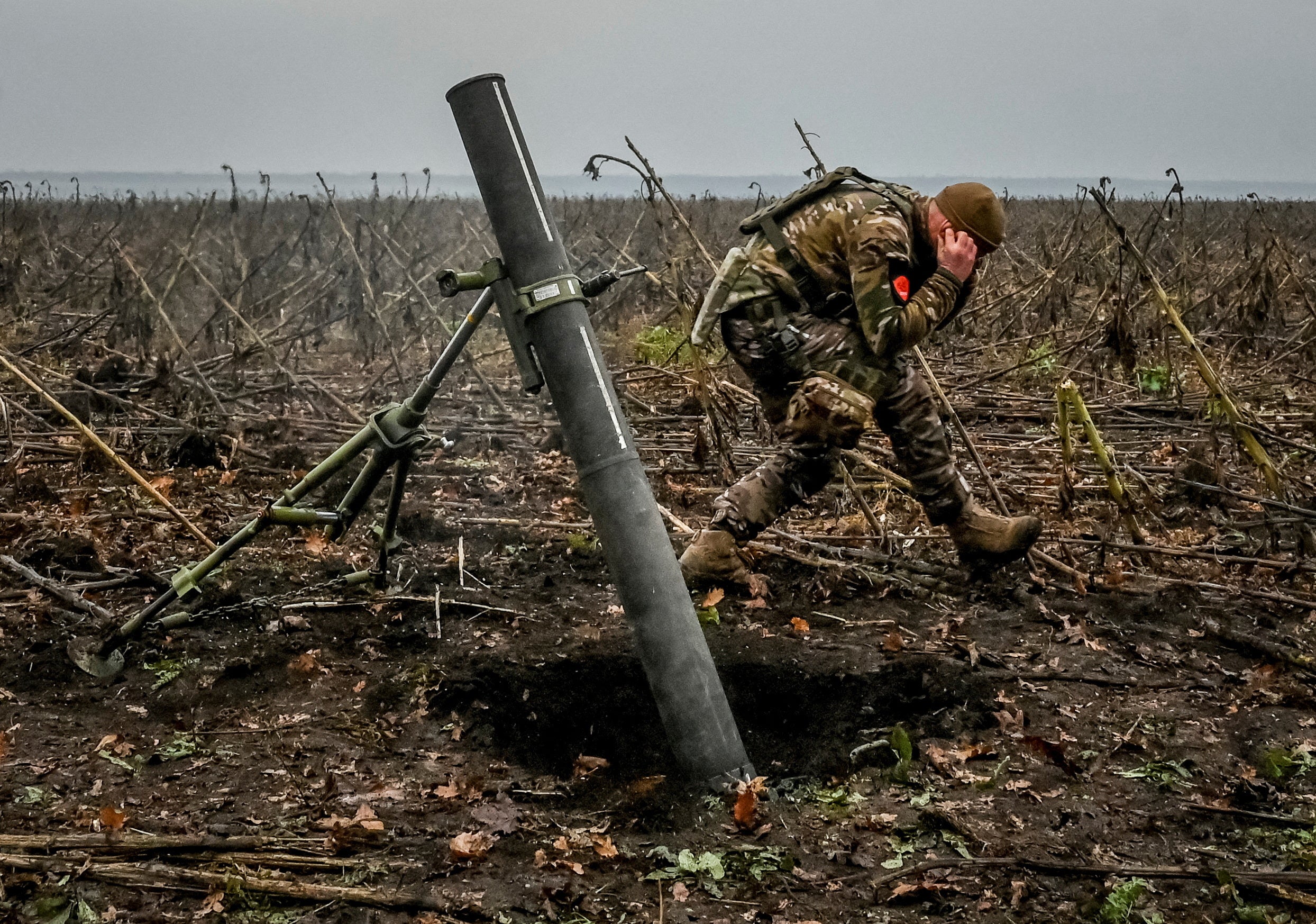 A Ukrainian serviceman fires a mortar on a front line in Zaporizhzhia