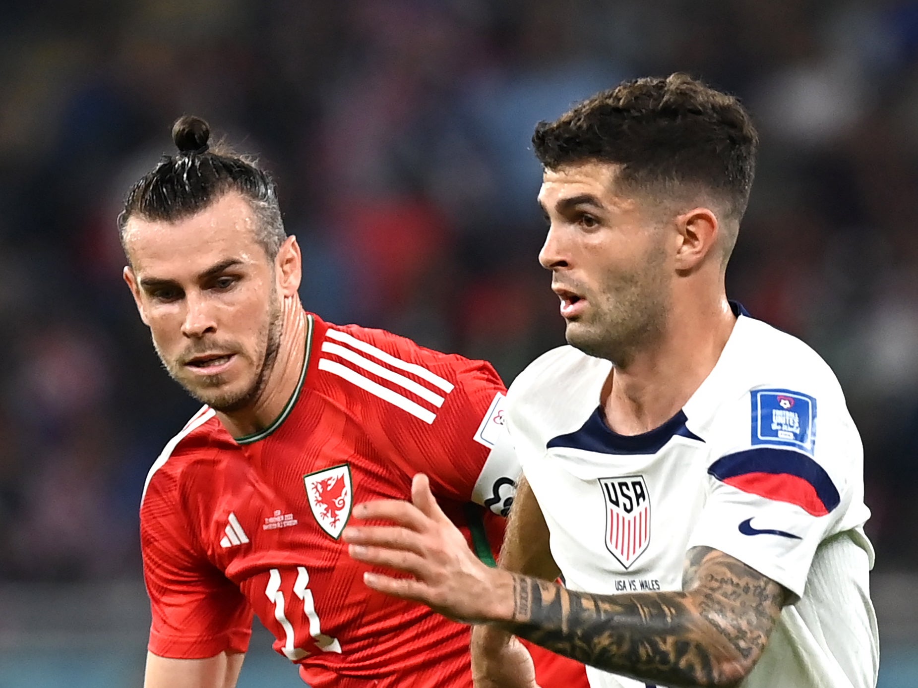 Wales captain Gareth Bale (left) vies with USA skipper Christian Pulisic