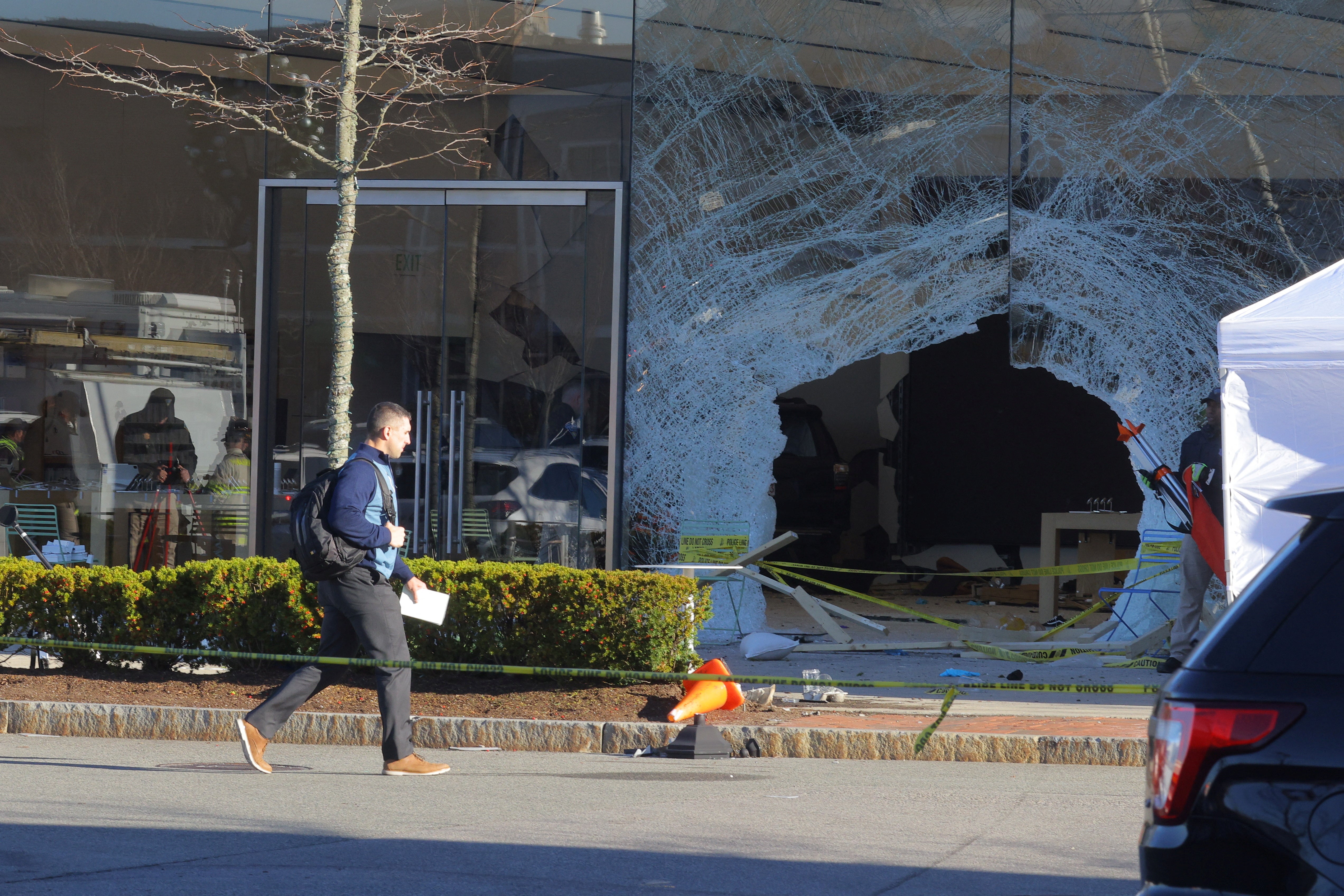 Emergency services personnel attend the scene after a vehicle crashed into an Apple store in Hingham, Massachusetts, U.S. November 21, 2022