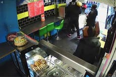 Moment hero restaurant owner wrestles with knifeman in shop