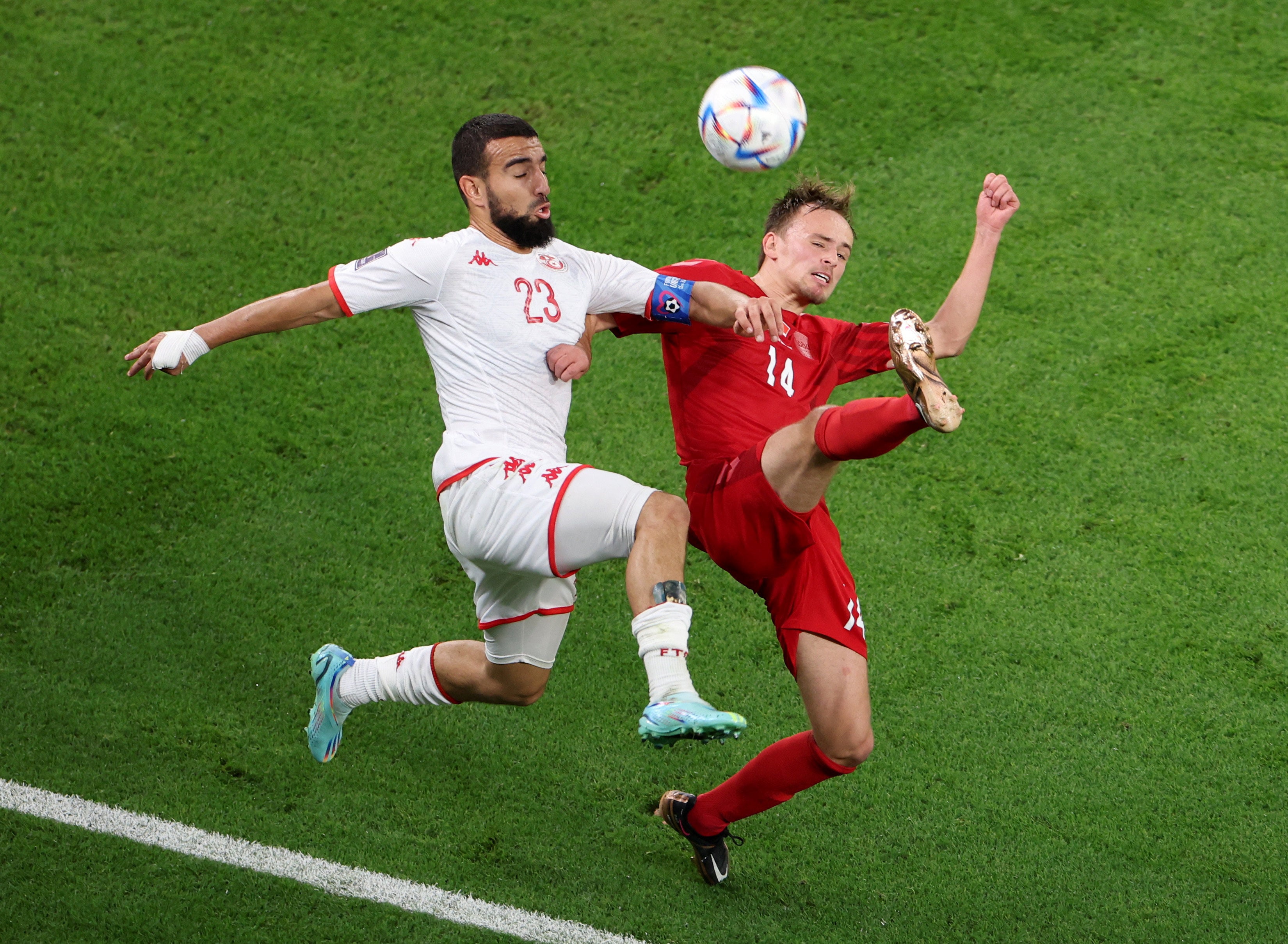 Tunisia’s Naim Sliti in action with Denmark’s Mikkel Damsgaard