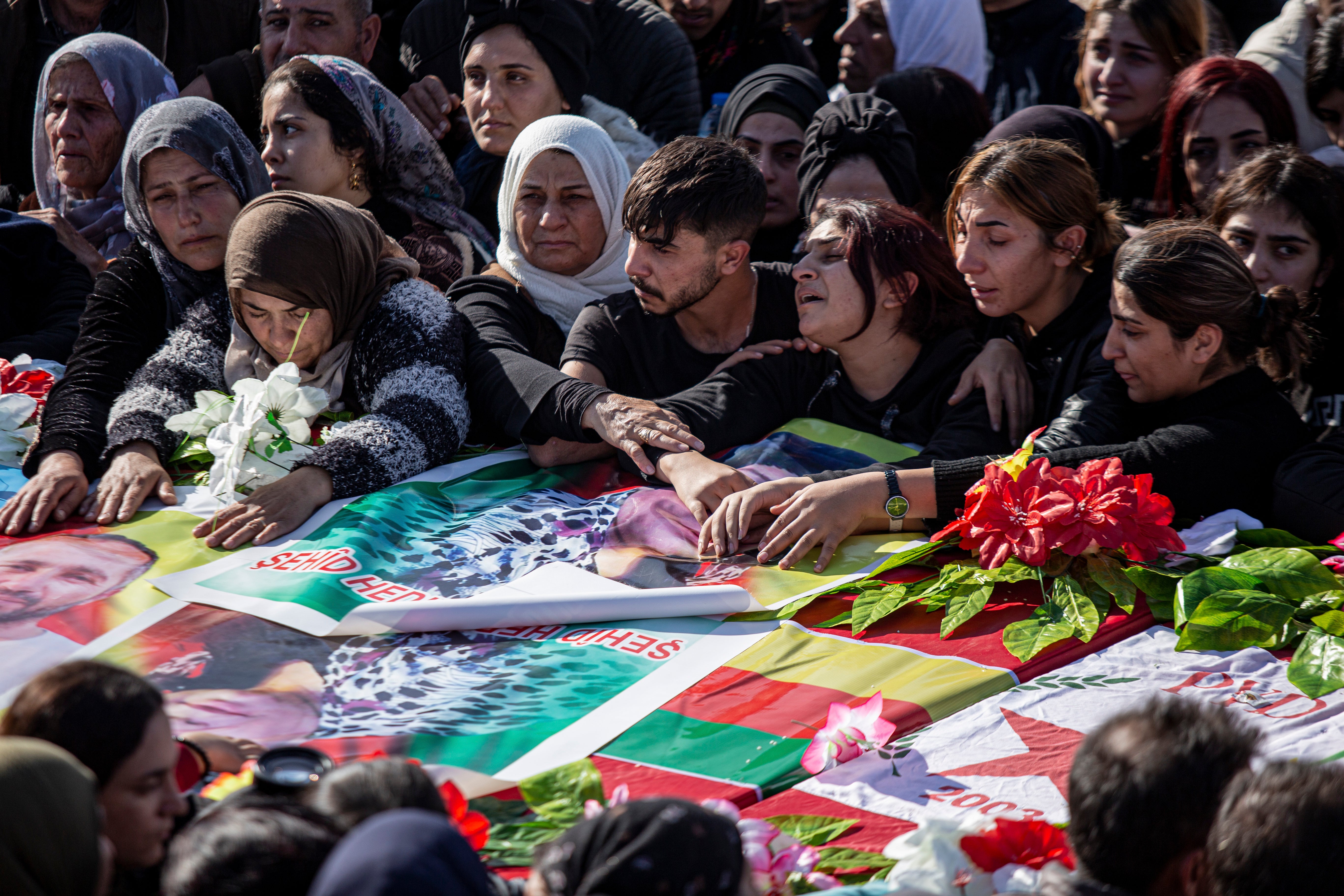 Syrian Kurds attend a funeral of people killed in Turkish airstrikes in the village of al-Malikiyah, northern Syria