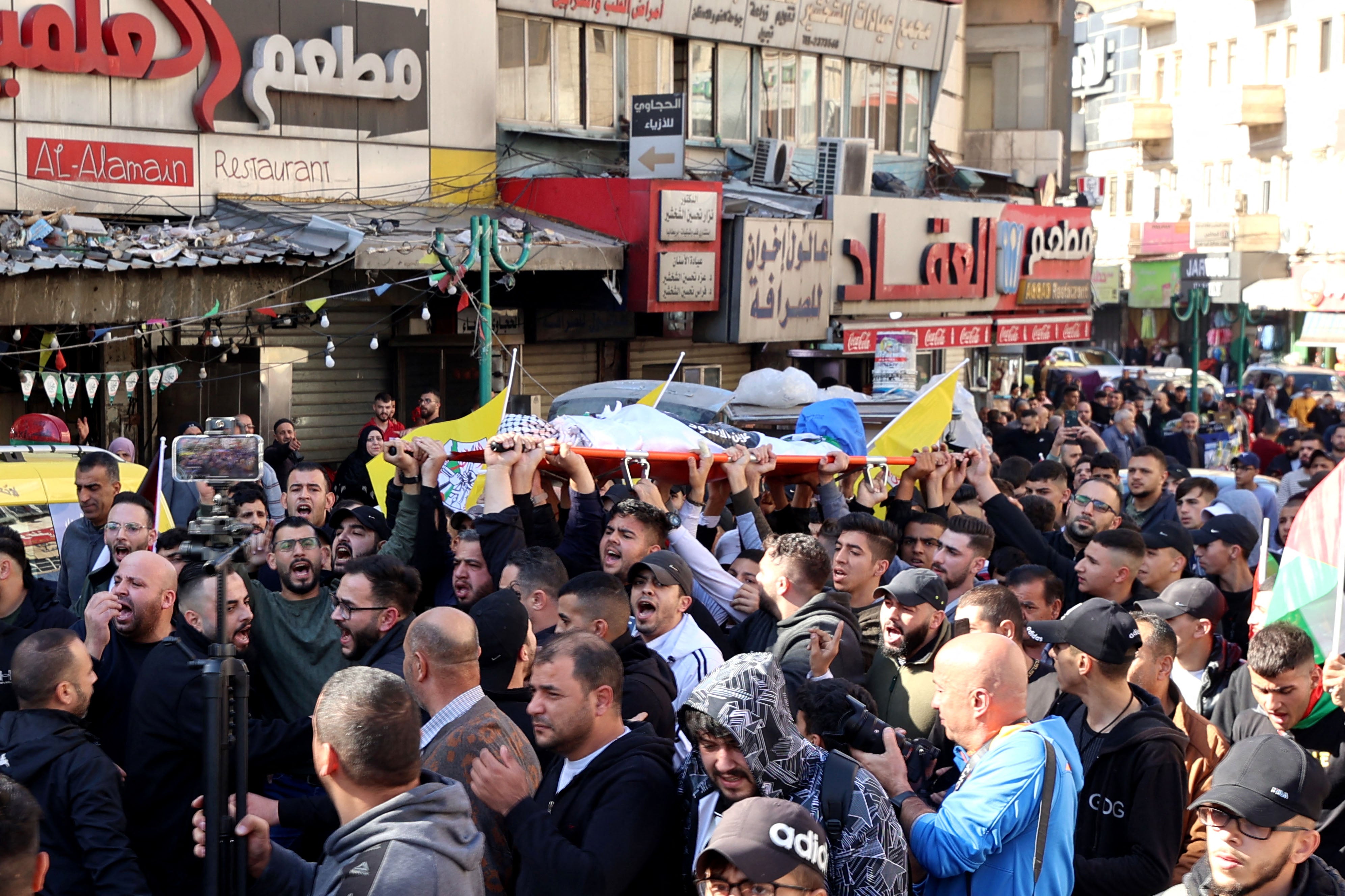 Palestinian mourners carry the body of 16-year-old Ahmed Amjad Shehadeh, who was killed during clashes with Israeli soldiers in the West Bank city of Nablus