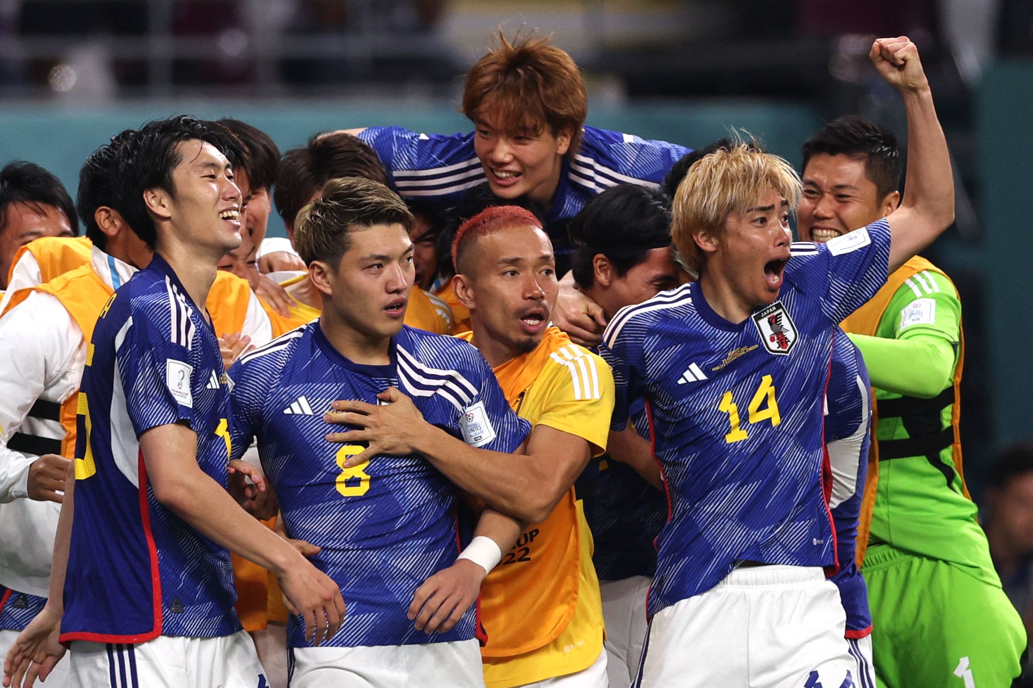 Japan’s players celebrate scoring against Germany