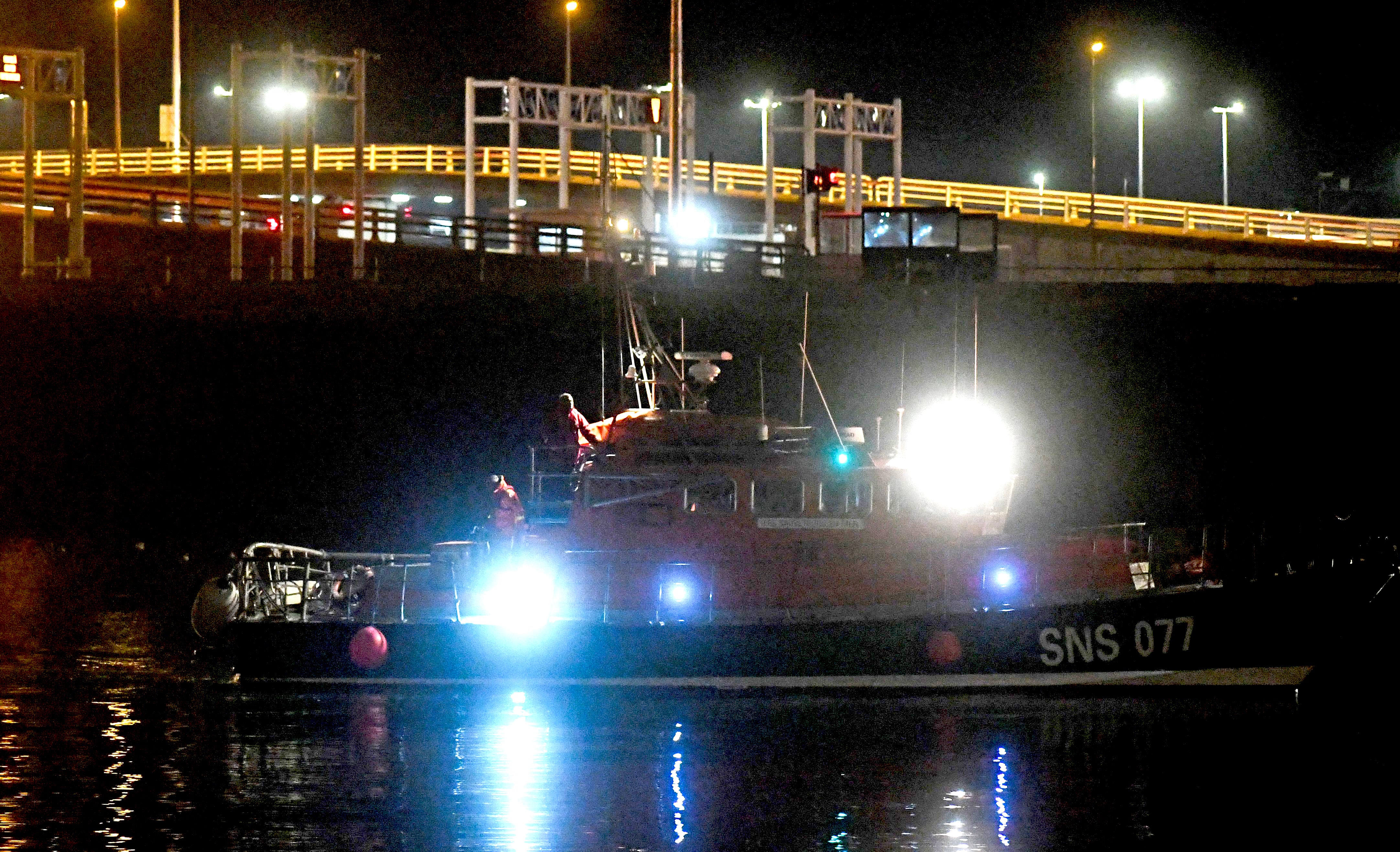 A French rescue boat carries the bodies of migrants, arriving at Calais harbour