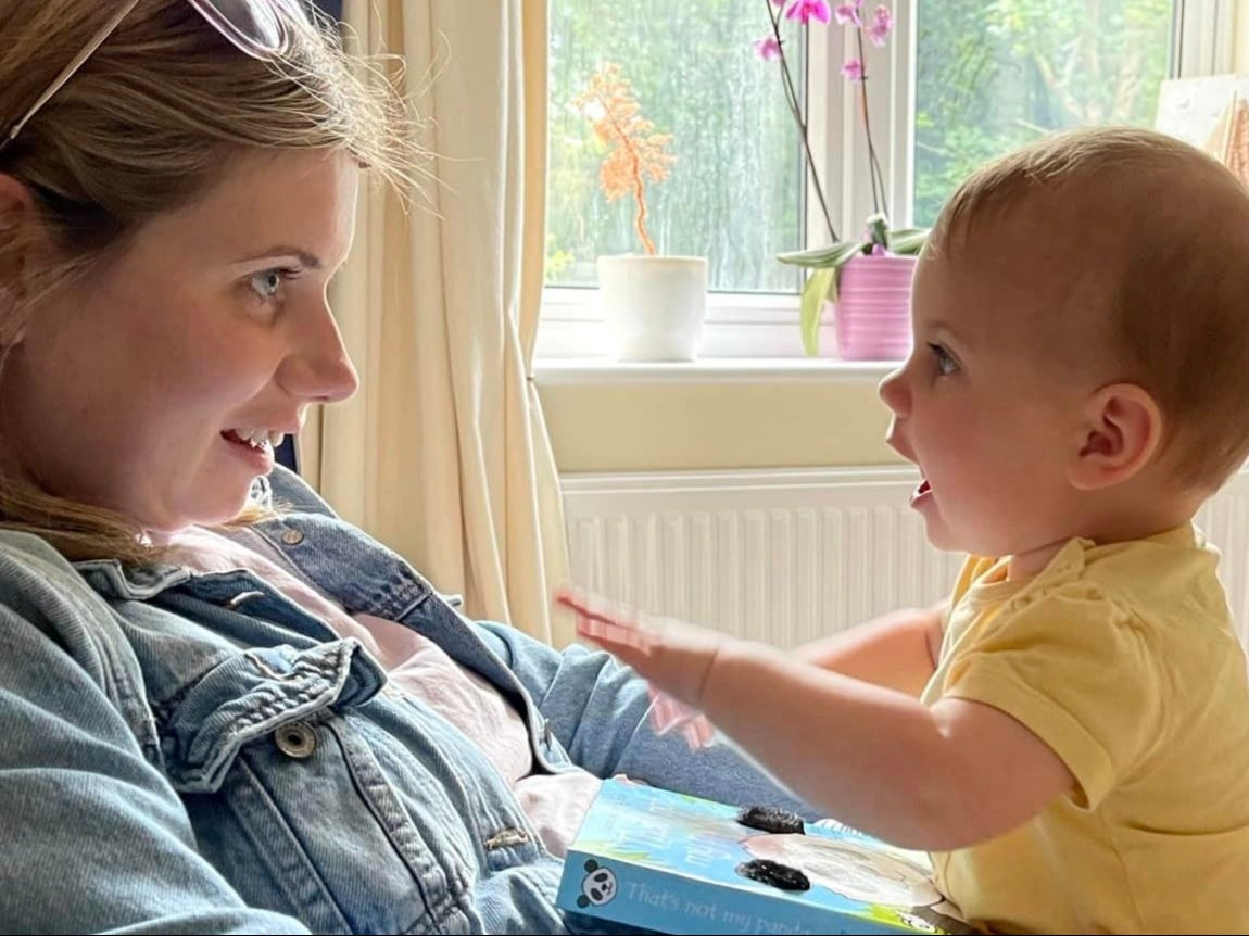 Rebecca bounces Autumn on her knee at their home in Willignham, Cambridgeshire
