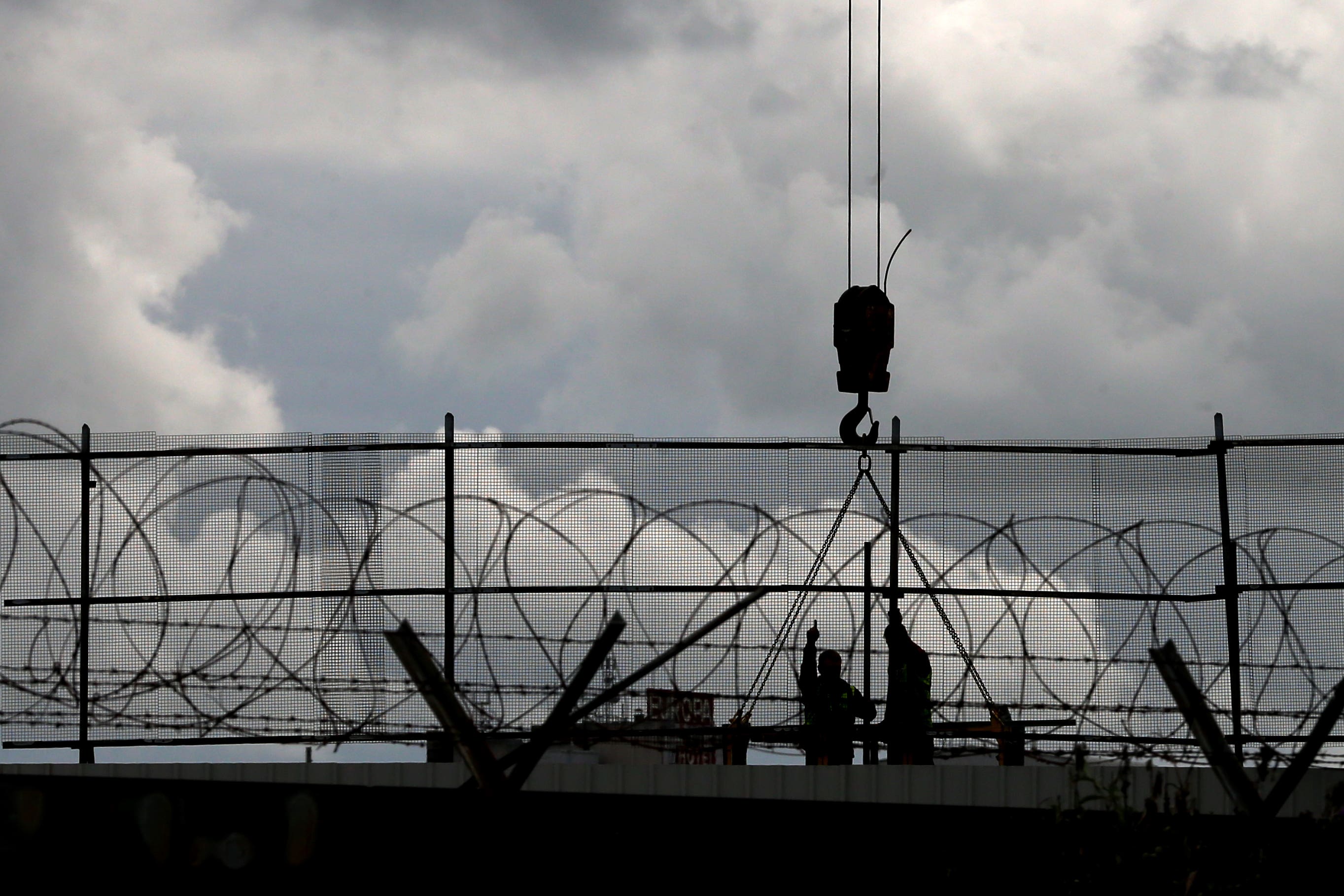 General repairs are carried out on one of Belfast oldest peace walls (Niall Carson/PA)