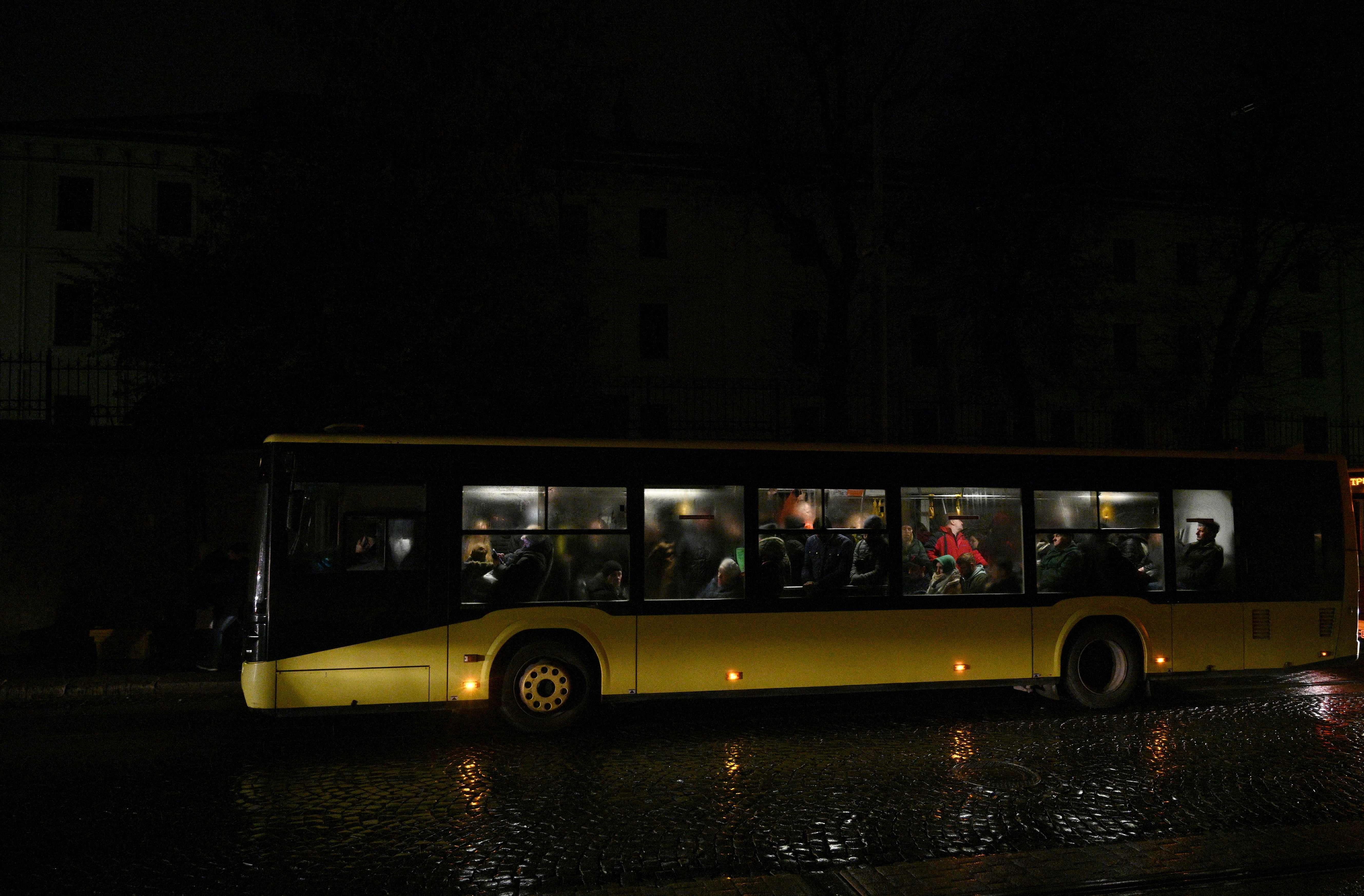 People ride on a city bus during a blackout in Lviv