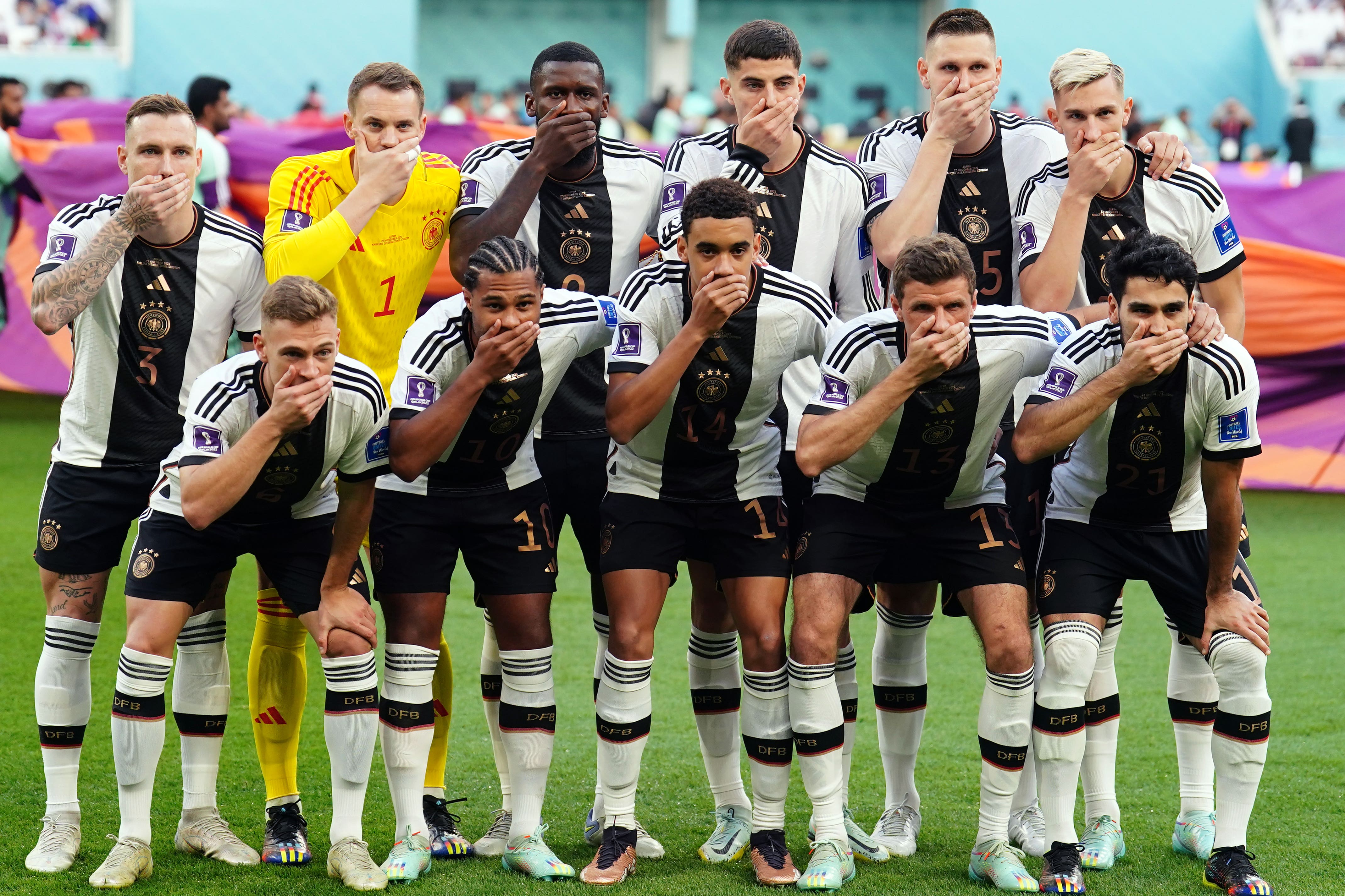 Germany players cover their mouths as a protest against FIFA