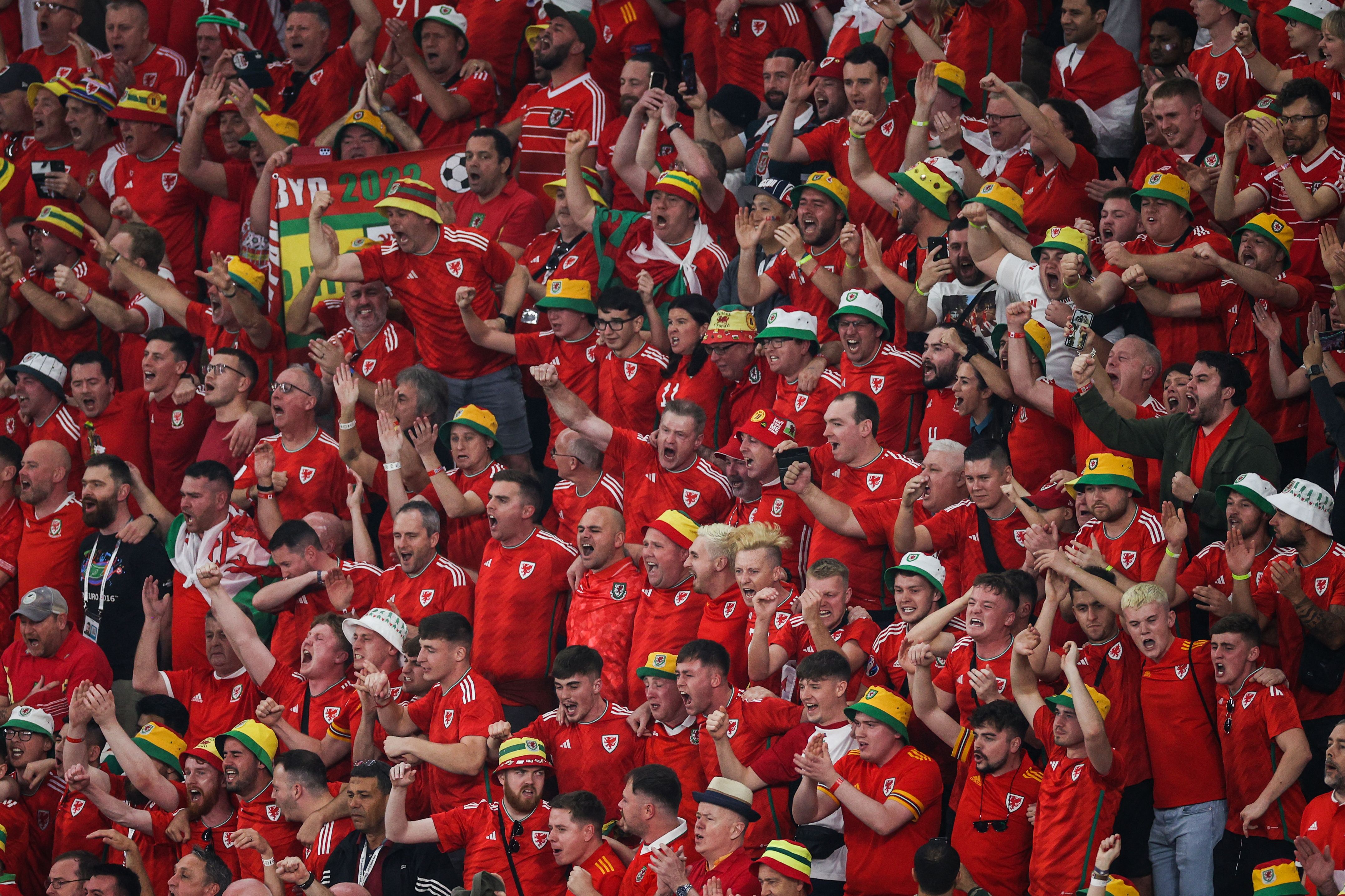 Wales supporters sing their national anthem ahead of the Qatar 2022 World Cup match between USA and Wales