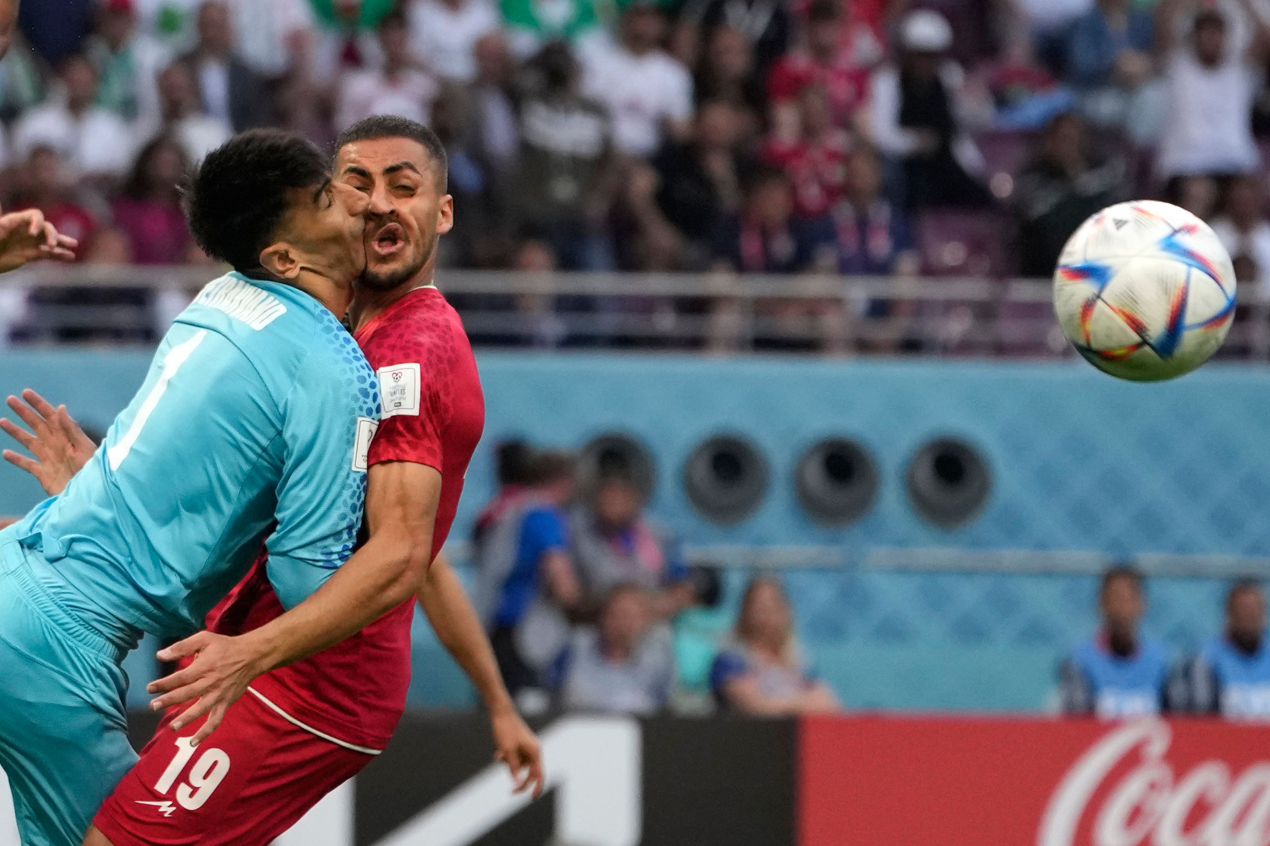 Iran goalkeeper Alireza Beiranvand collides with team-mate Majid Hosseini (Alessandra Tarantino/AP)